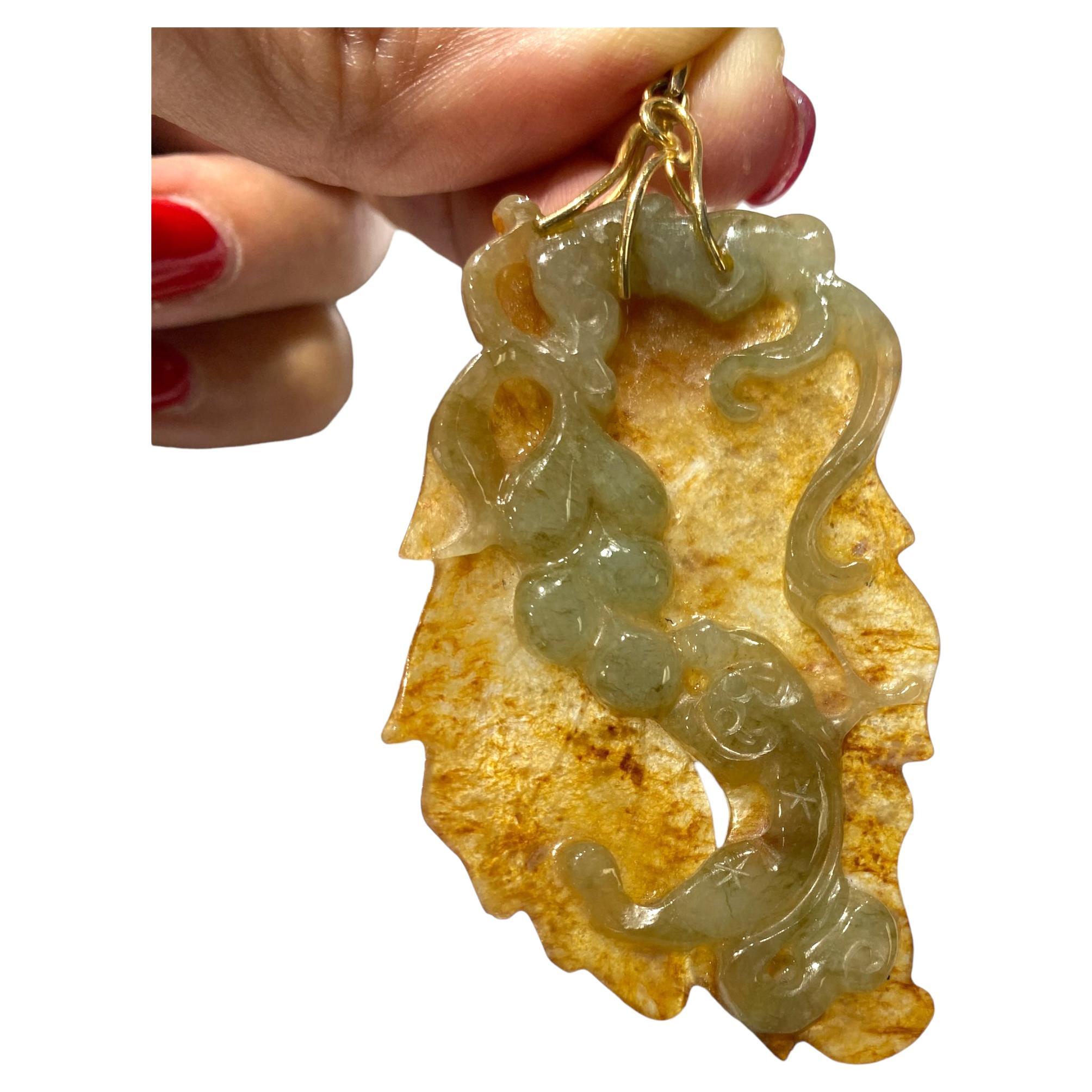 Translucent high-quality jade at its finest is exceptionally rare. The top carving of green jade depicts a salamander with a grapevine. The Brownish color jade is the grapevine and is highly translucent. The back side is the carving of the leaf