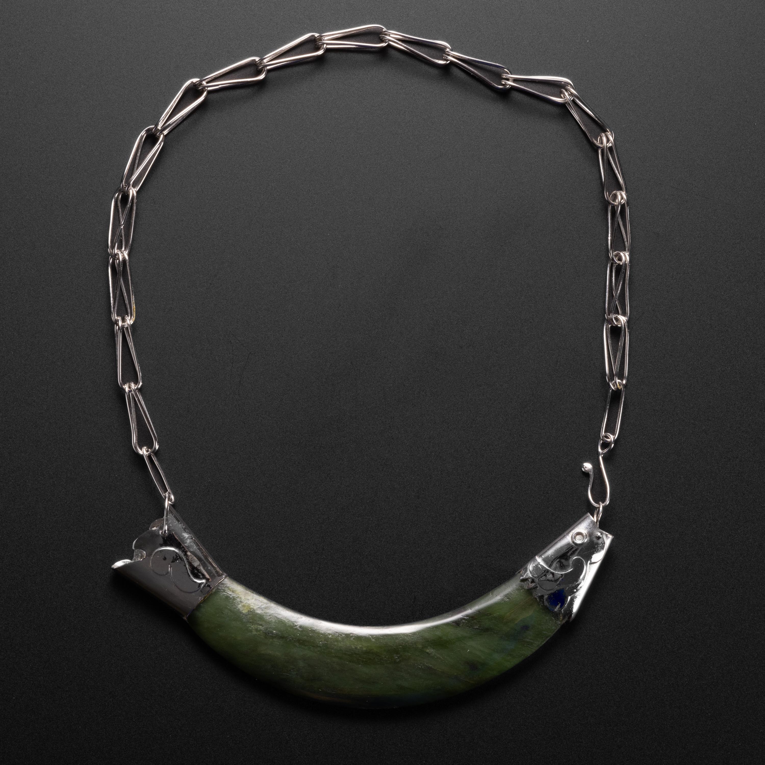 This rare and substantial choker-length necklace was created by Arthur Court Designs in 1976 from sterling silver and a sizeable carved nephrite stone. The necklace depicts a fish and the clever hook joins the necklace at the mouth of the fish.

The