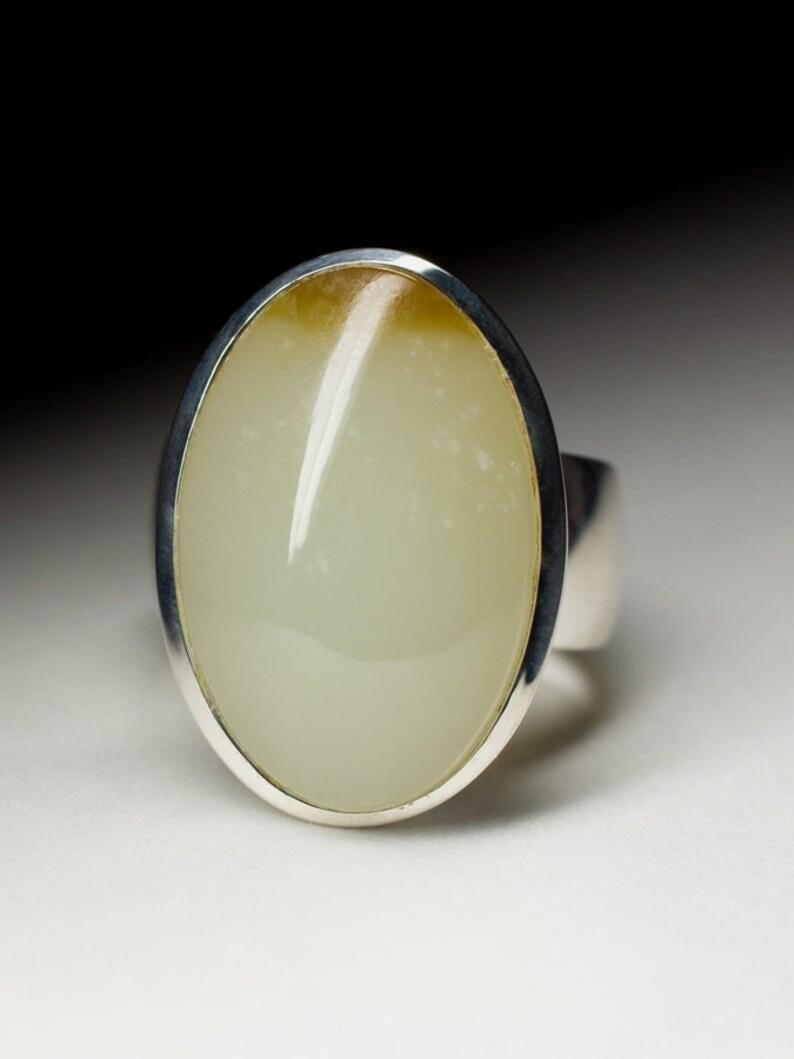 Silver ring with natural Jade - Nephrite 
nephrite weight - 17.20 carat 
stone measurements - 0.28 х 0.63 х 0.98 in / 7 х 16 х 25 mm
ring size - 8.5 US
ring weight - 13.79 grams