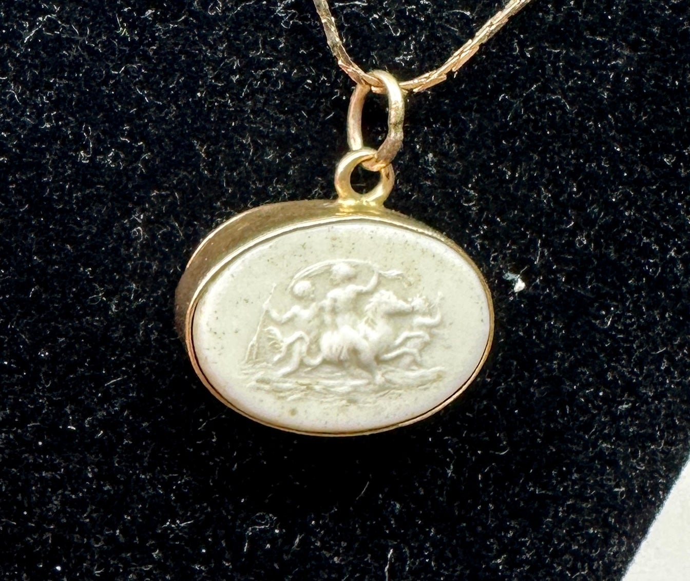 Indulge in a stunning antique Victorian Cameo Pendant with an image of the God Neptune or Poseidon rising out of the sea with a maiden on horseback set in 12-14 Karat gold.  Leading the procession out of the water is Pan with his horn.
The antique