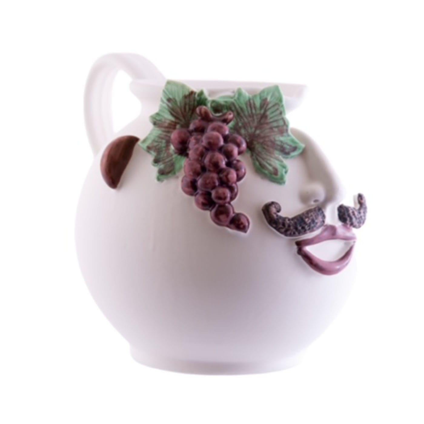 The large Nerello pitcher, embodying the essence of a black grape merchant, is a stunning piece crafted from white clay and adorned with a smooth, matte cream glaze complemented by vibrant second fire colors. Versatile in its use, this figurative