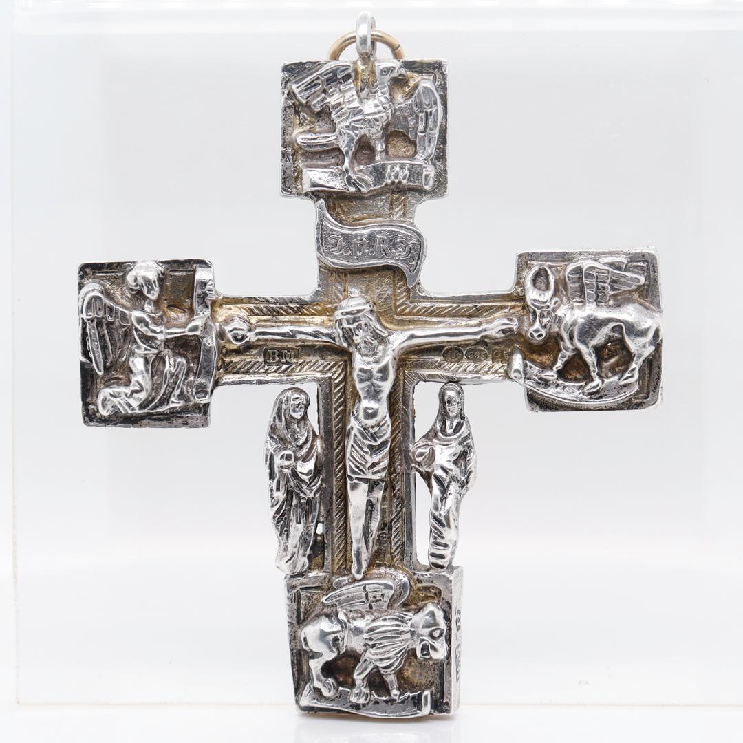 A fine antique Gothic Revival silver crucifix or cross.

In sterling silver.

By Neresheimer & Sohne of Hanau, Germany. 

In the form of Christ on the cross - with an I.N.R.I plaque above his head and the 4 animals of the Christian tetramorph to