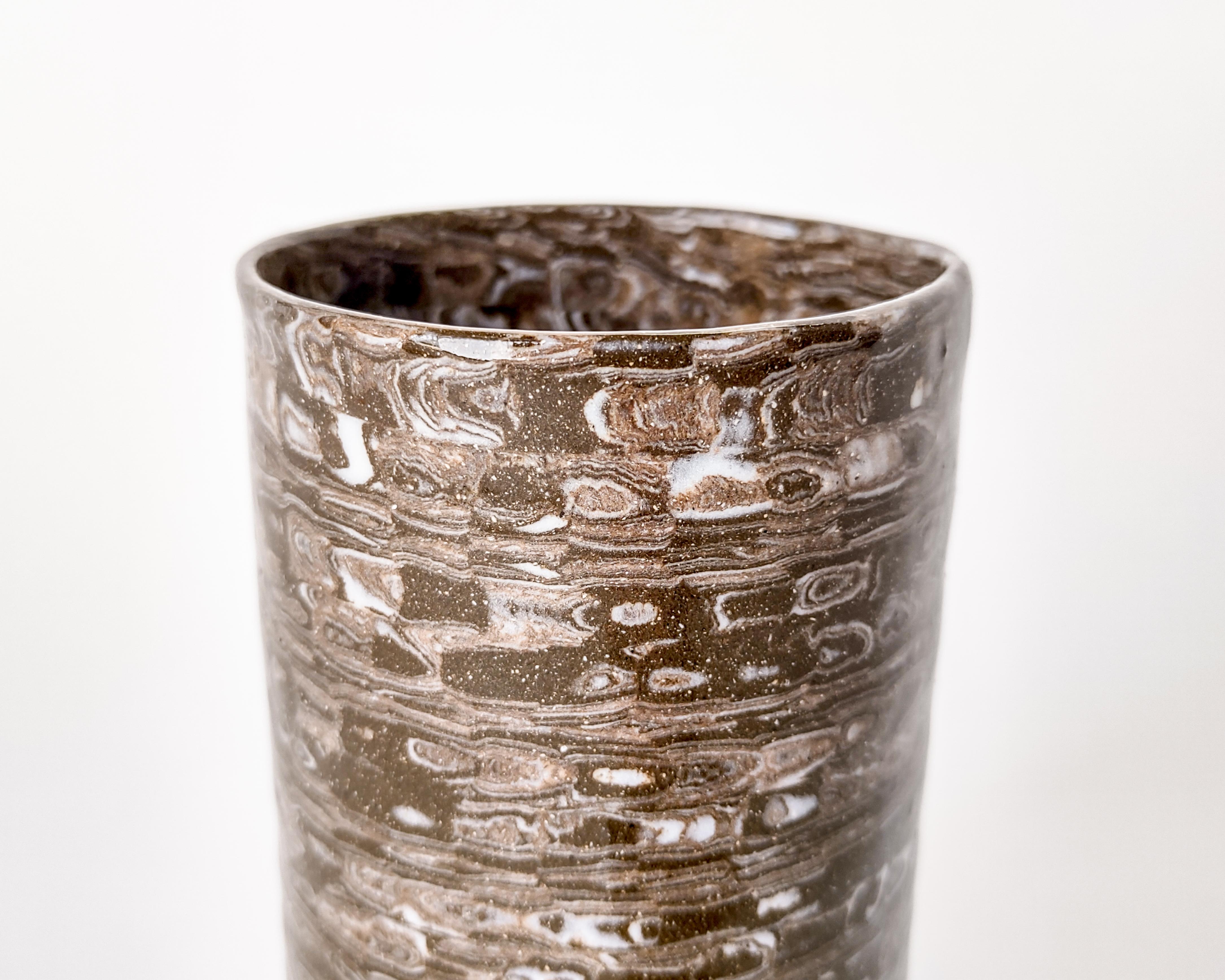 Handmade nerikomi vase with multiple colored clays. Black-brown speckled clay with colorful details integral to the vase. Made and fired in Los Angeles by Fizzy Ceramics in 2022. Glazed clear on the outside and inside, the black clay turns brown