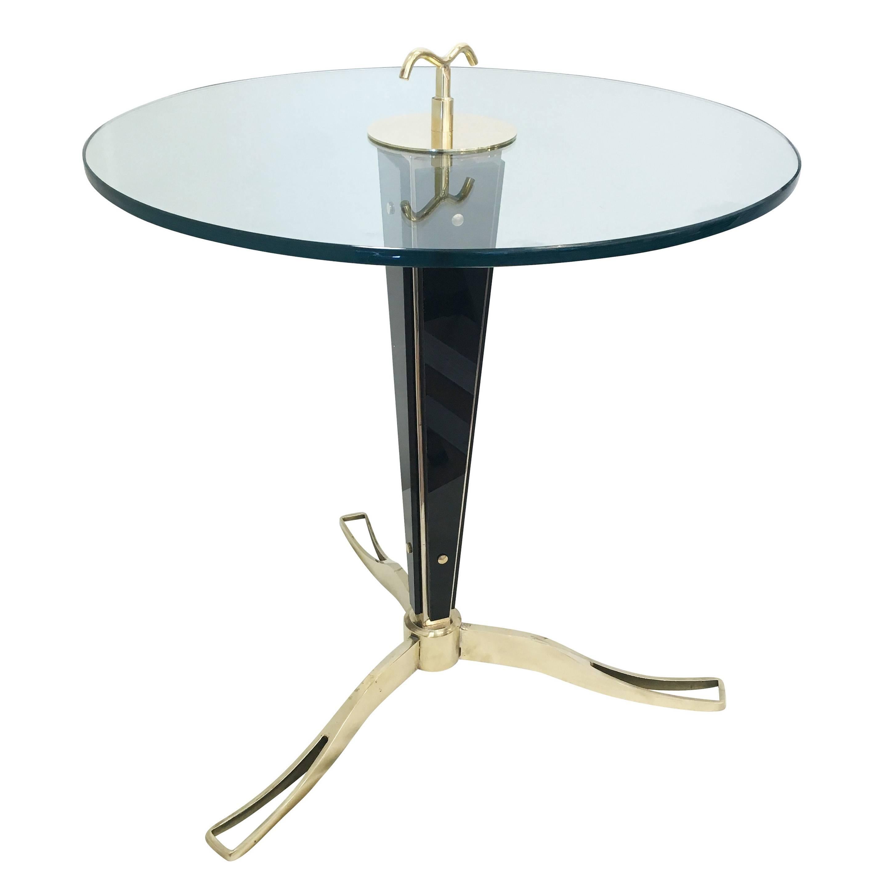 Glass and brass side table designed by Italian artisan Daniele Bottacin for Gaspare Asaro’s studio collection, formA. Each piece is composed of a brass frame holding four pieces of black glass and has a beautifully detailed base and