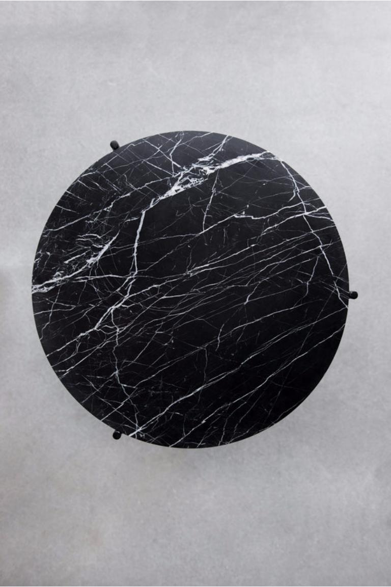 The Nero Granada Side Table is a sophisticated accent piece that balances minimalism with natural beauty. Its round Nero Marquina marble top features natural veining that is emphasized by the understated matte black base made of round stock