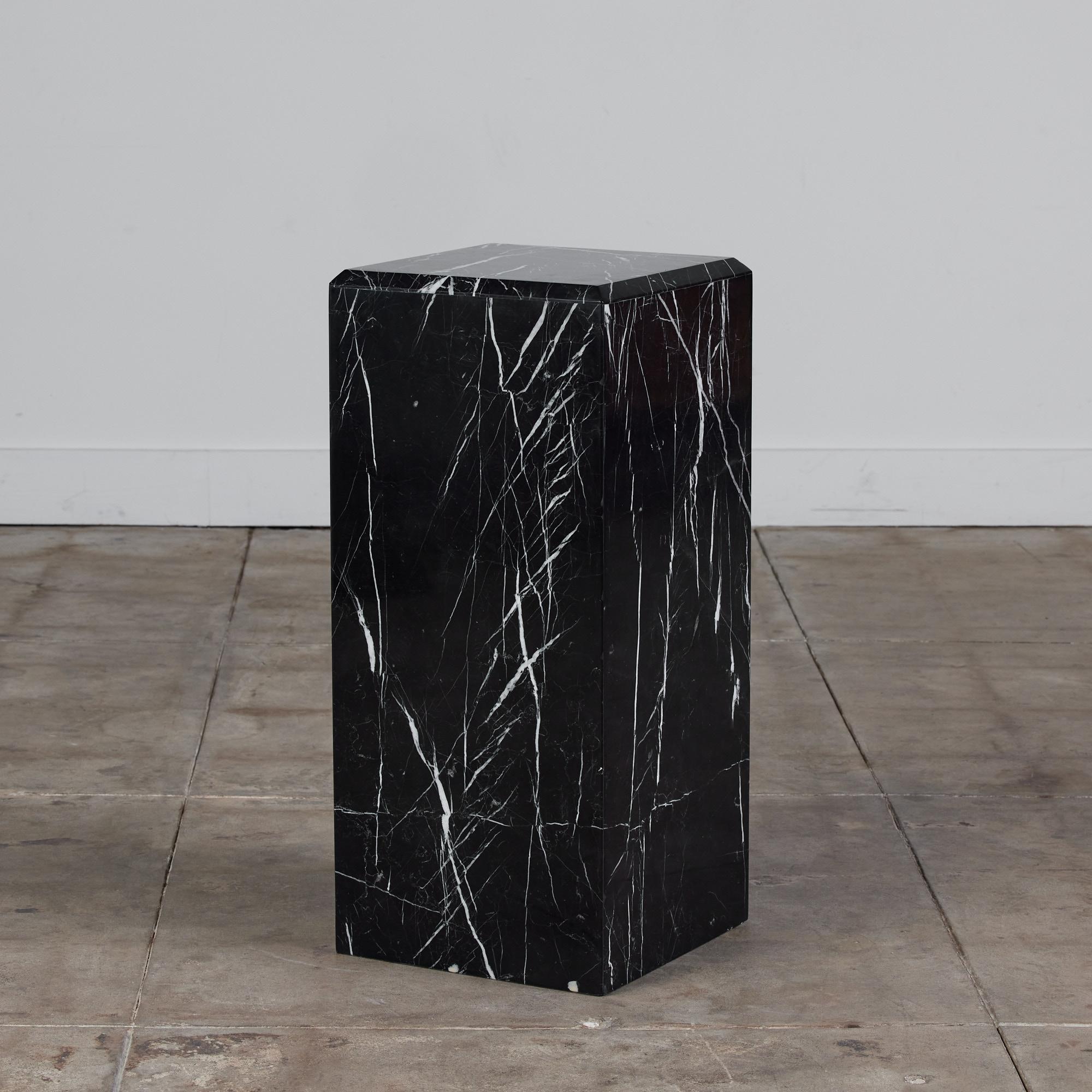 Stone pedestal in a stunning Italian Nero Marquina marble with white veining in the style of Angelo Mangiarotti. This timeless piece can be a sculptural piece of art or it can beautifully display an object upon its surface. The column pedestal