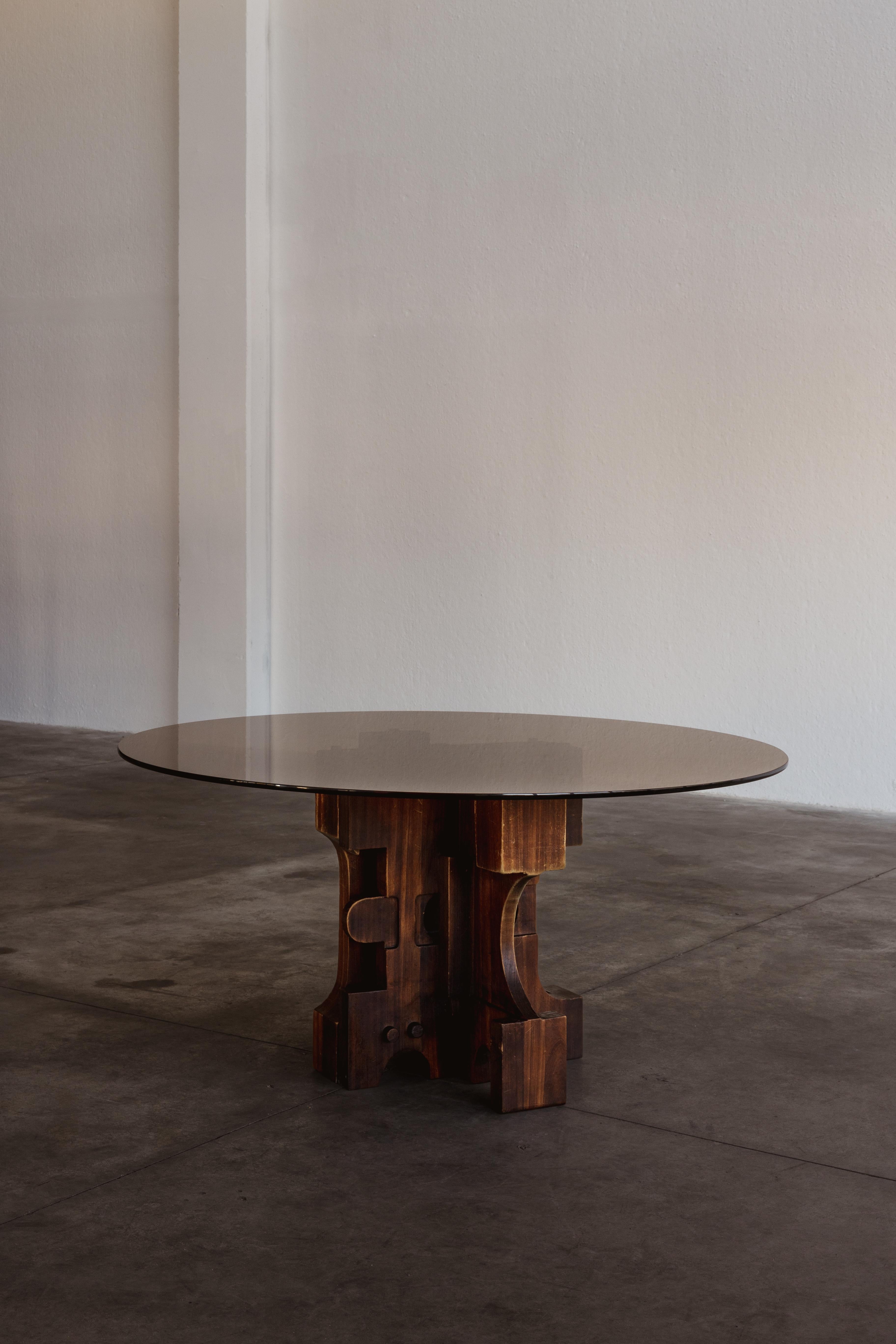 Nerone & Patuzzi dining table for Gruppo NP2, glass, iron and wood, Italy, 1970s.

Designed by the Italian duo Nerone and Patuzzi, this dining table is a work of art. The base consists of an asymmetrical layout of geometric elements that vary in