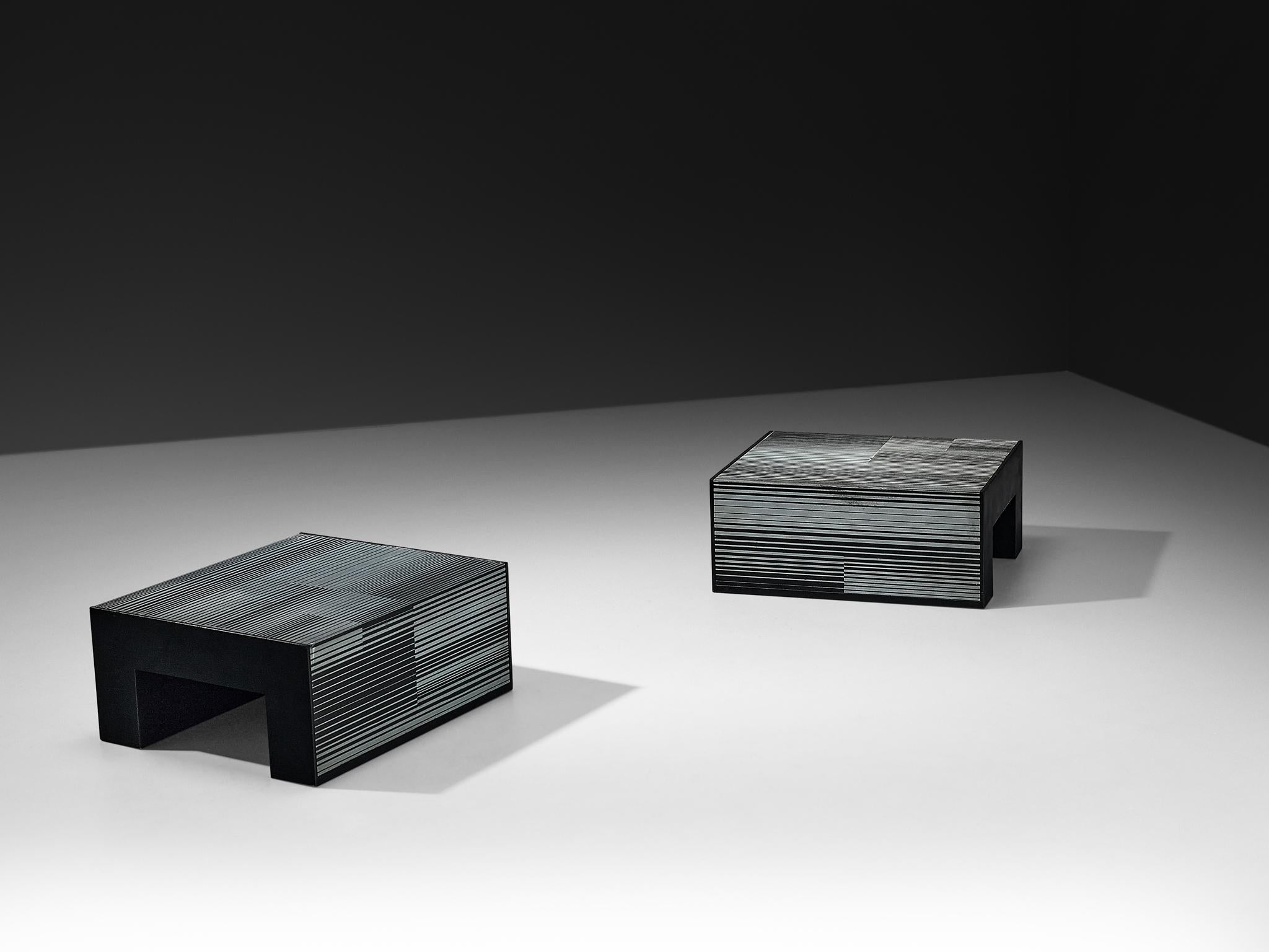 Giovanni Ceccarelli and Gianni Patuzzi for Gruppo NP2, pair of coffee tables, black enameled wood, zinc, Italy, circa 1975

These coffee or side tables, created by the renowned Gruppo NP2, have a compelling and interesting design. The tables are