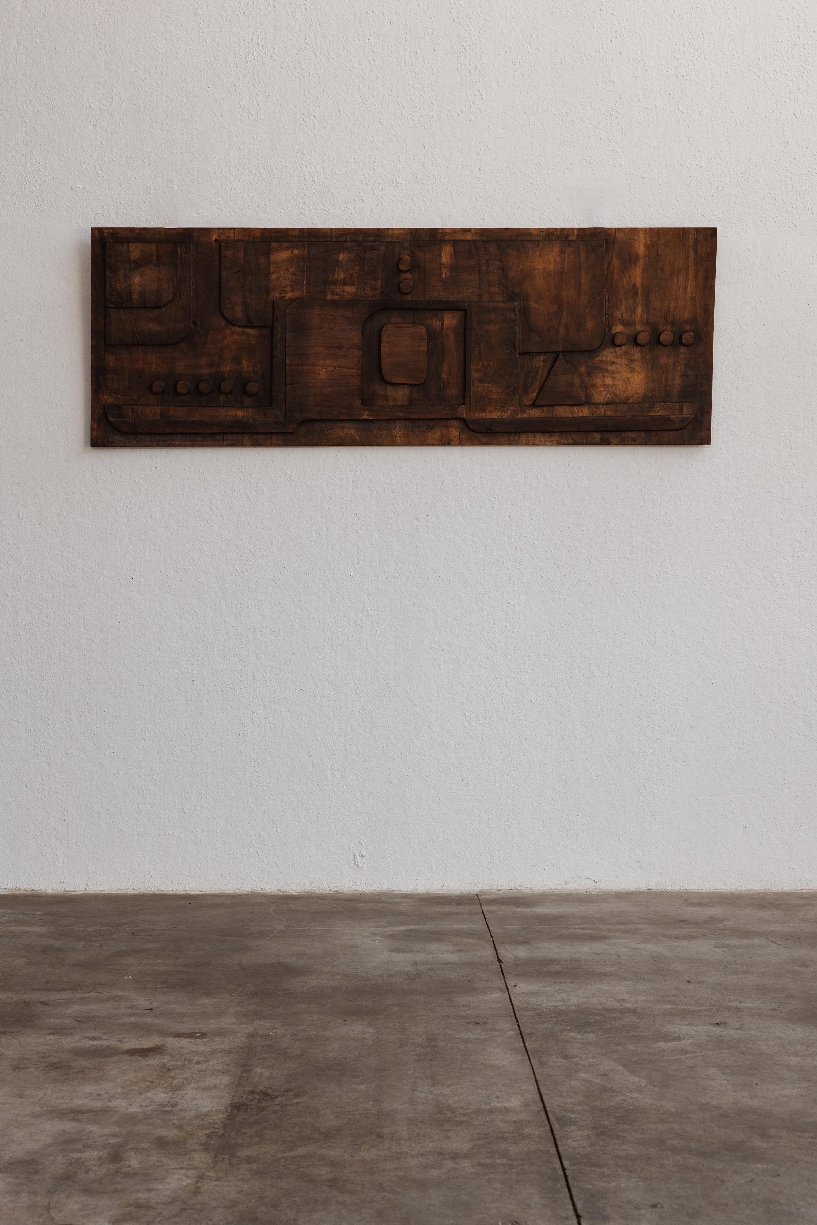 Nerone & Patuzzi cculptural wooden  wall panel for NP2, mahogany, Italy, 1973.

This untitled sculpture panel, created around 1970, features linear, curved, concentric, and triangular motifs with an ethnic flavor. The all-encompassing component is