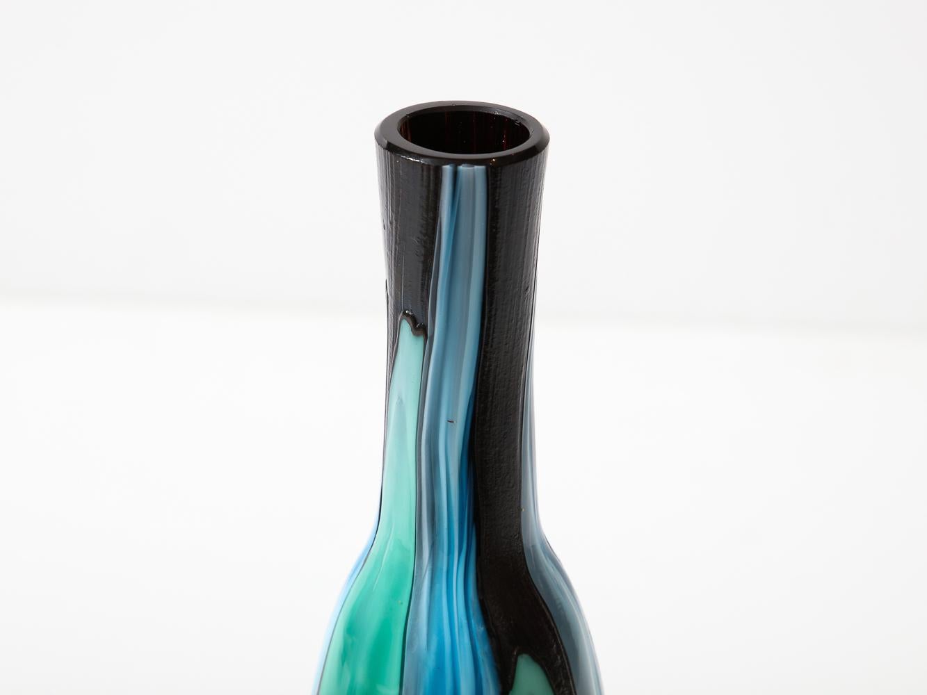 Vibrantly colored, opaque blown glass bottle.