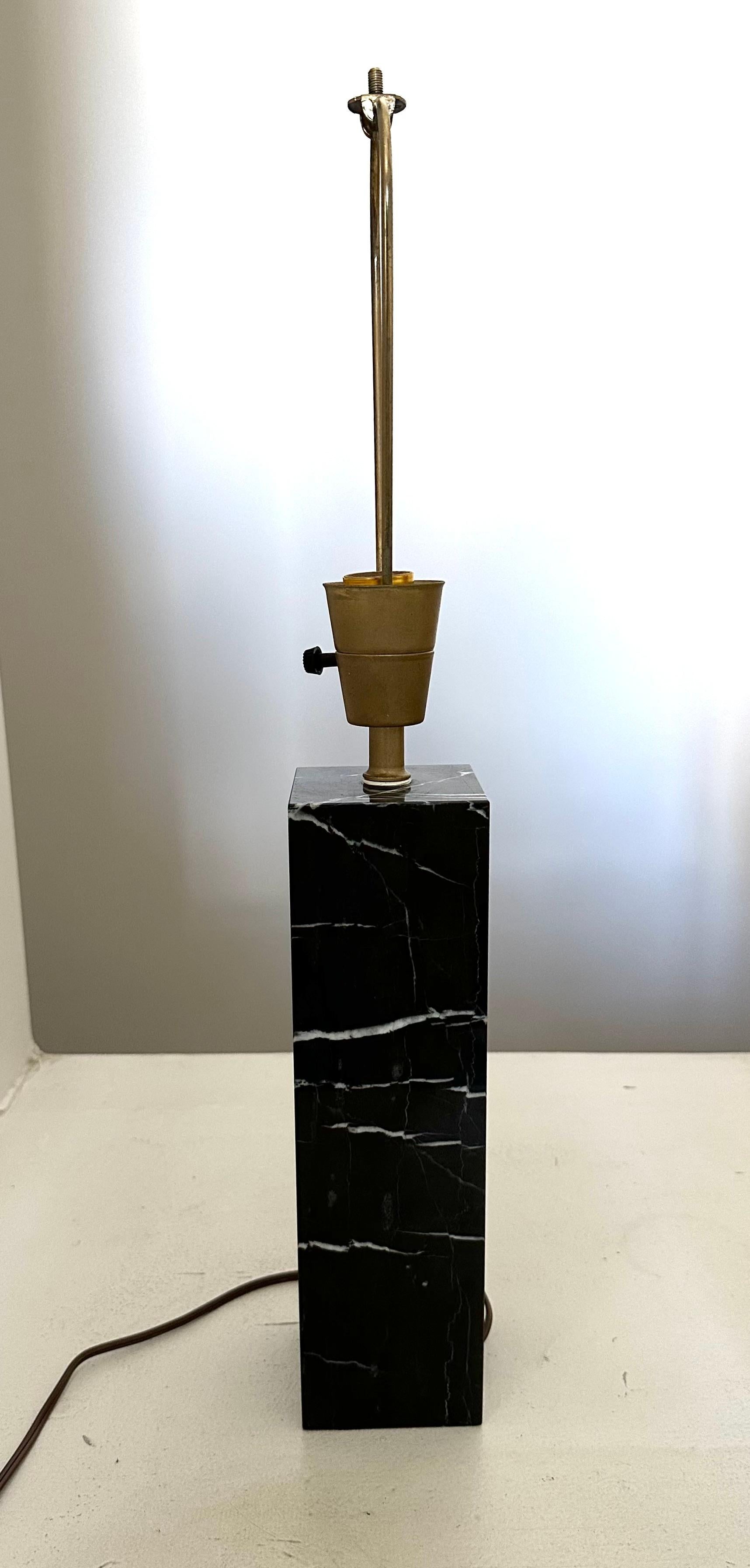Chic square variegated black marble column lamp  with white veining. Original patinated brass hardware is in good working condition.   15.5