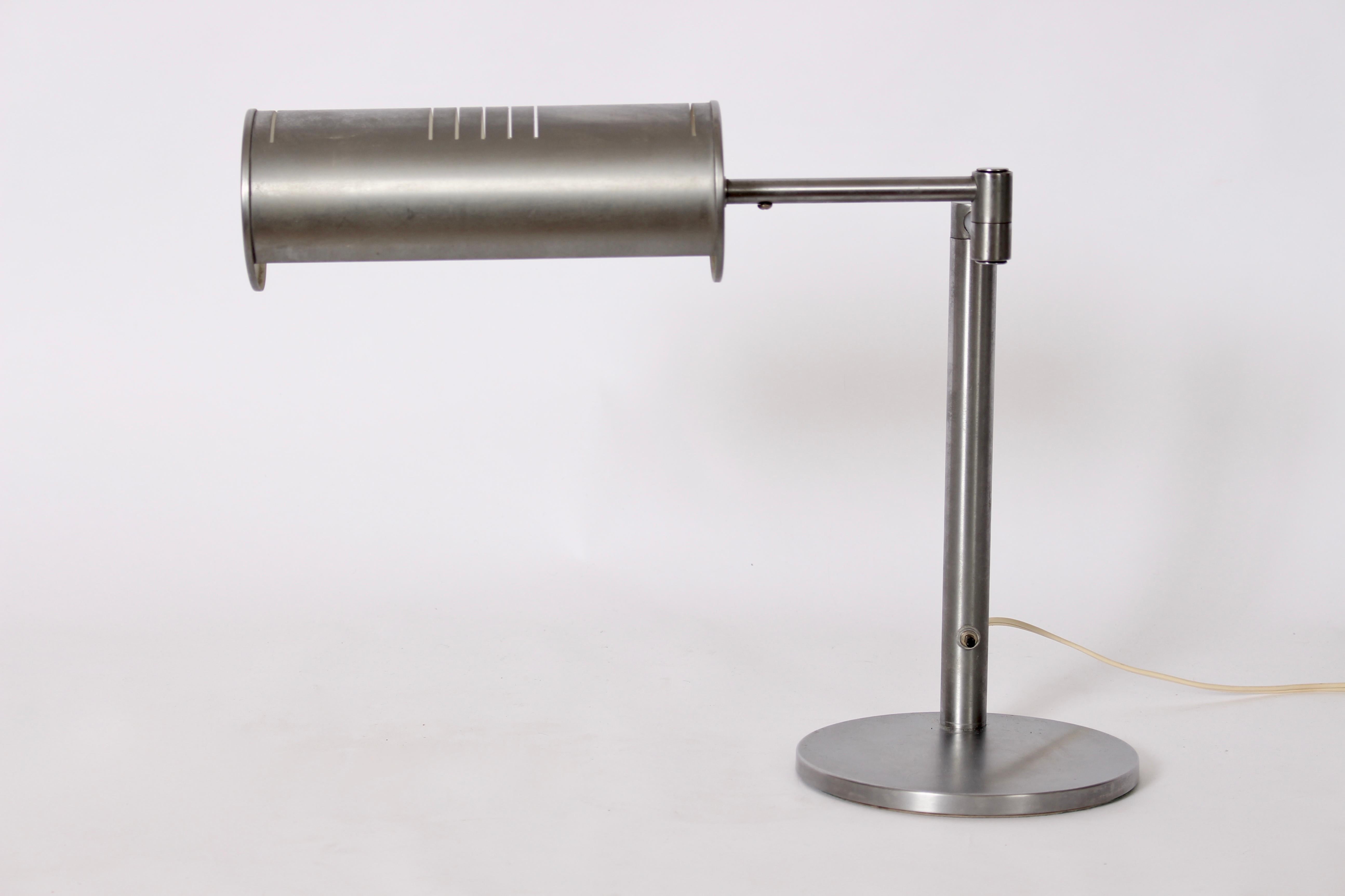 Nessen Studios Brushed Steel Swing Arm Desk Lamp with extending and adjustable Cylinder Shade. This Classic Nessen design rarely seen in all Brushed Steel features a perforated swing shade (extending to 15L) and sturdy round 8D base, wIth column