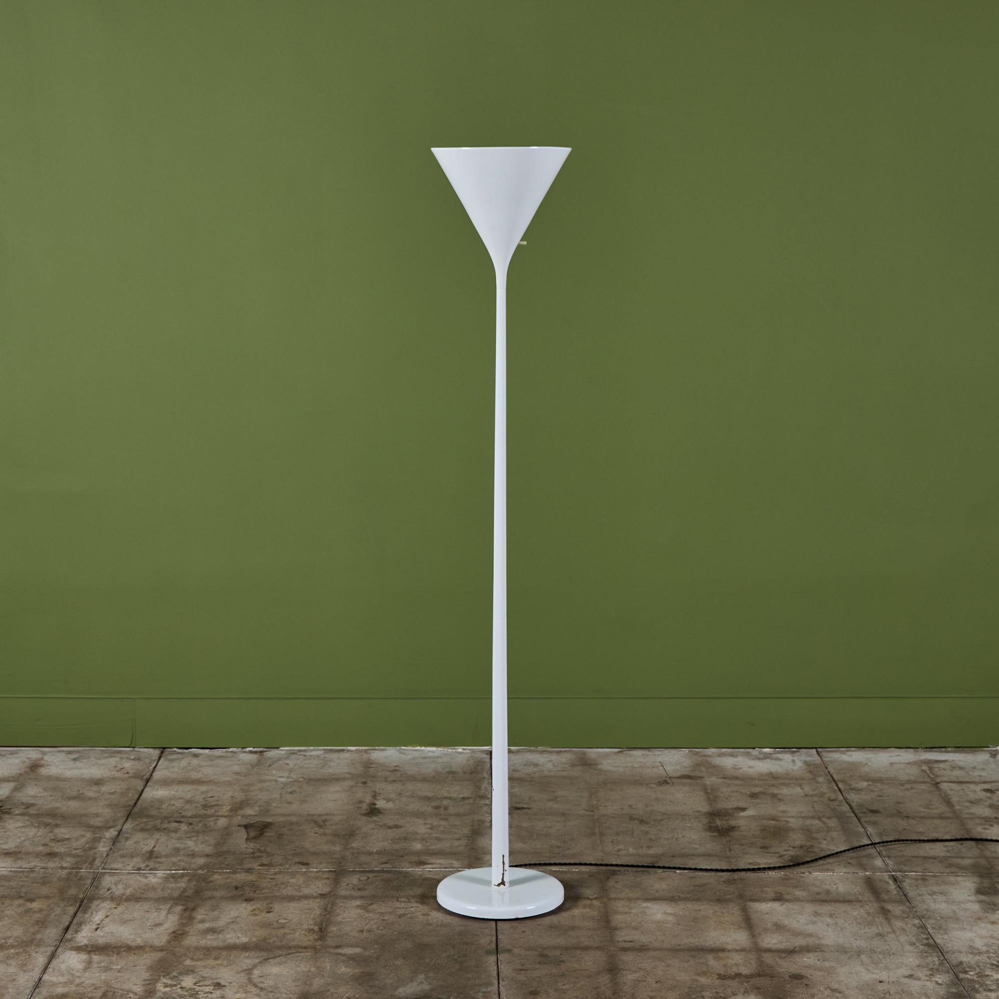 White enamel floor lamp by Nessen Studios. The modern lamp features a cone shade that directs light upwards and an on/off switch at the bottom of the shade.


Dimensions
11