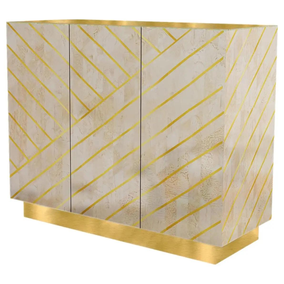 Nesso Small Sideboard with Brass Inlay by Matteo Cibic is a beautiful cabinet in pearly resin with geometric brass inlay and a luxurious brass top. It comes in three colors, beige, gray and mint. Custom sizes, colours and finishes are available on
