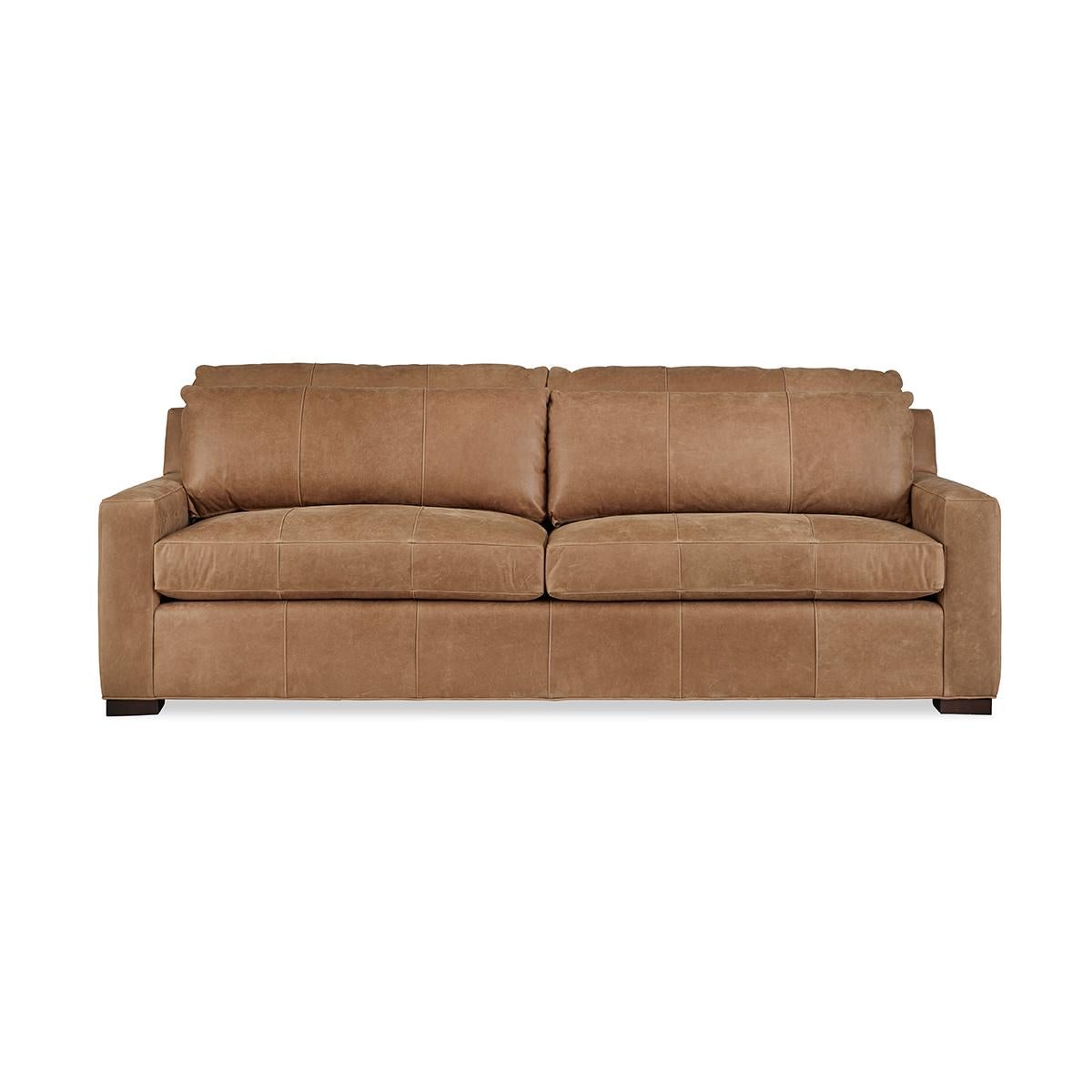 Modern leather upholstered sofa with bold modern lines and raised on bold square block feet. Long loose pillow backs with two long comfort down seat cushions.

Completely Made in USA, with traditional 8-way hand-tied construction and US grown -