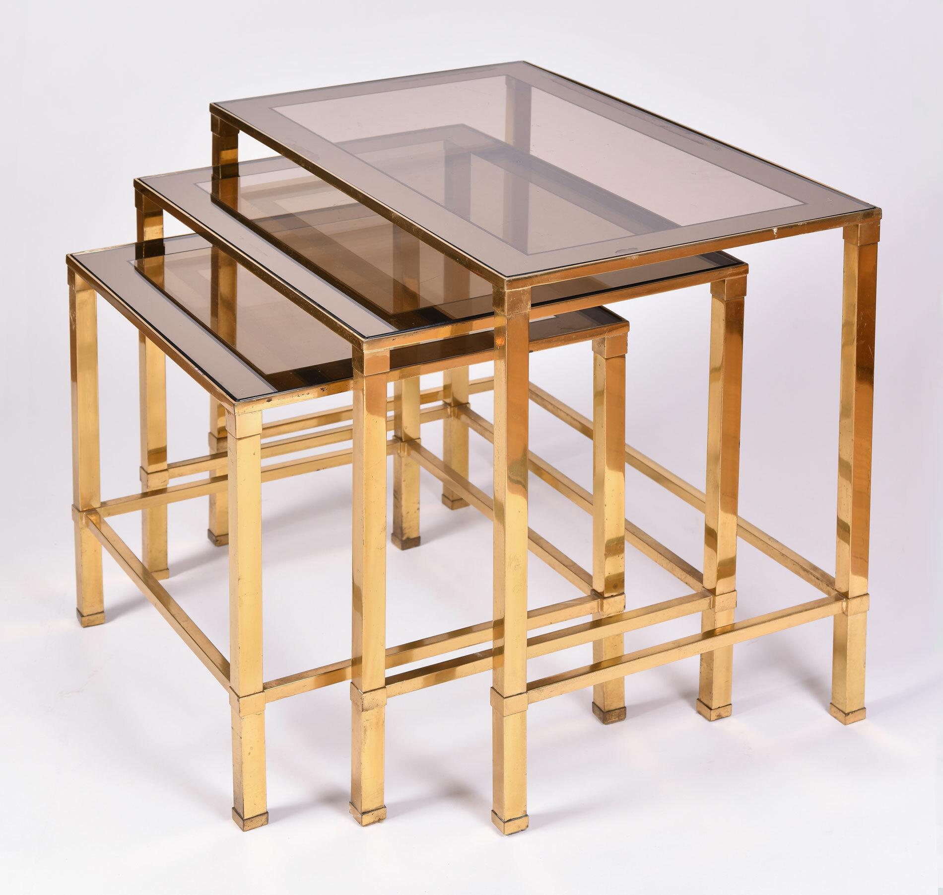 Rectangular nest of three Italian brass side tables. Each table inset with smoky glass with mirrored surround.