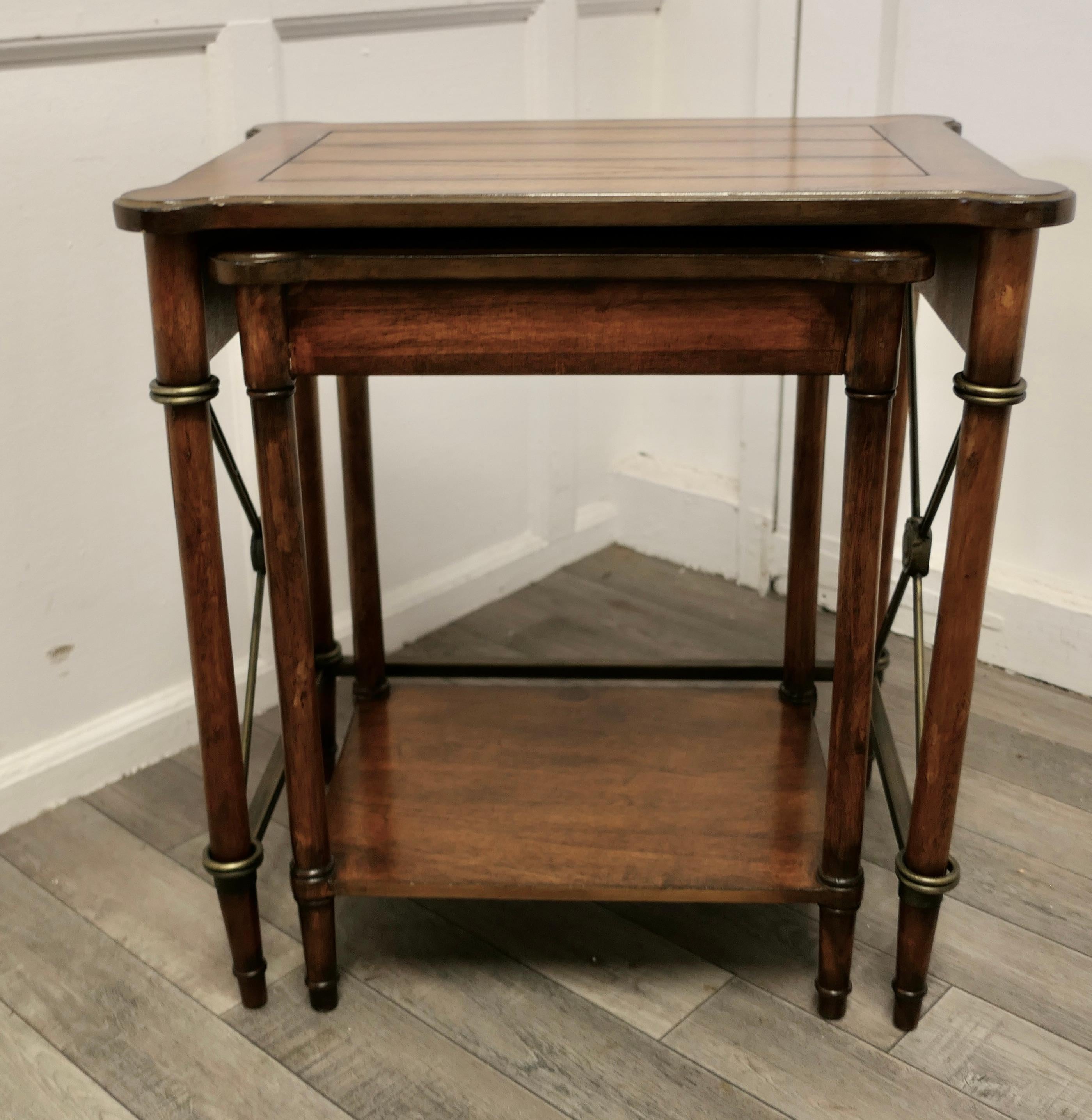 Nest of 2 Regency style walnut and brass occasional tables

A very attractive pair of occasional tables with a regency look, the smaller of the 2 fits under the larger table, like a nest of tables, they are in good used condition 
The larger