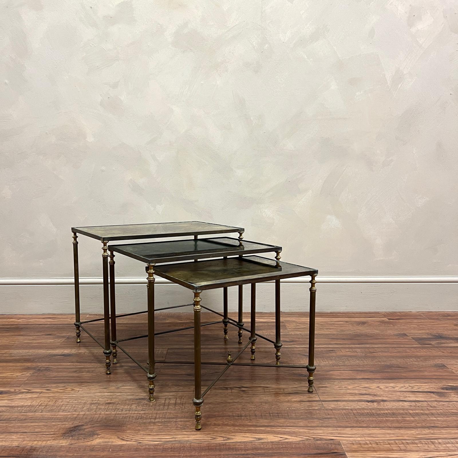 Nest of 3 brass, graduating side tables by Maison Baguès , rich eglomise glass.
Reeded legs sitting on detailed brass feet.

France, circa 1940.

Largest 
Height - 45 cm
Width - 54.5 cm
Depth - 37.5 cm

Smallest 
Height - 37 cm
Width - 40.5 cm
Depth