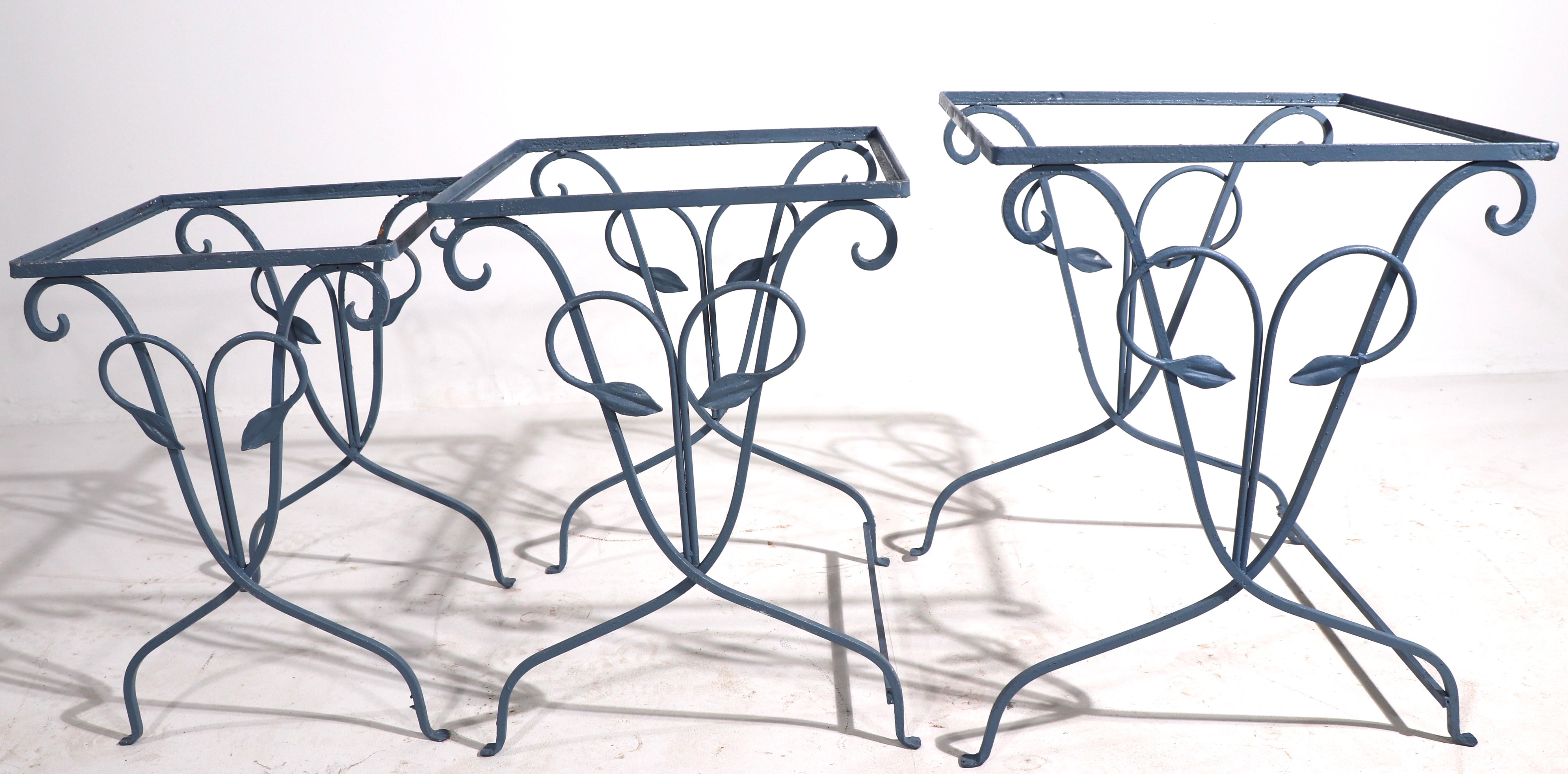 Charming set of three nesting tables in decorative wrought iron foliate pattern. Very well crafted, quality vintage metalwork, currently in later blue paint finish. Unusual to find sets of three still together and intact. Selling without glass