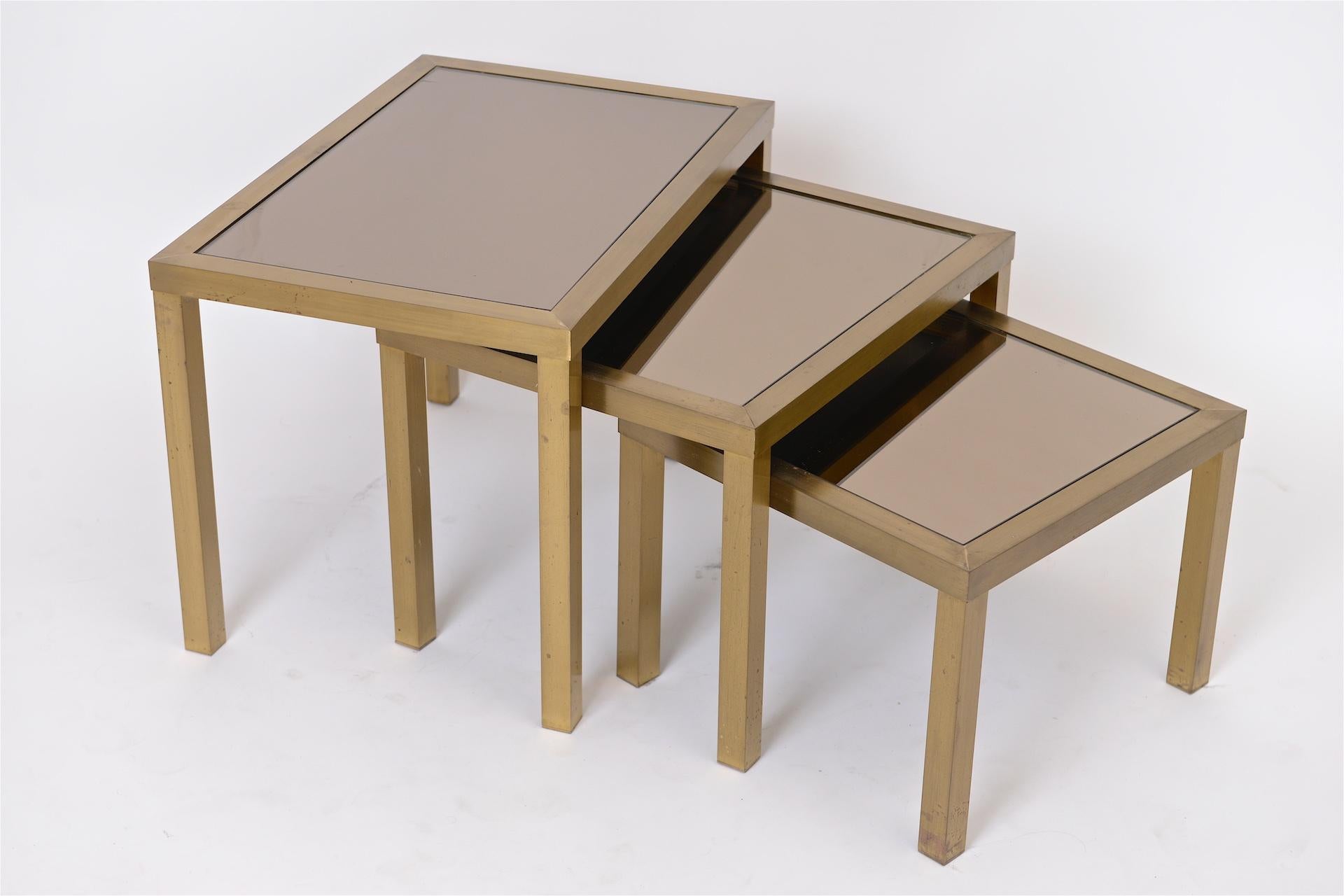 Brass tables with bronze mirror.

Size is for largest table.

 