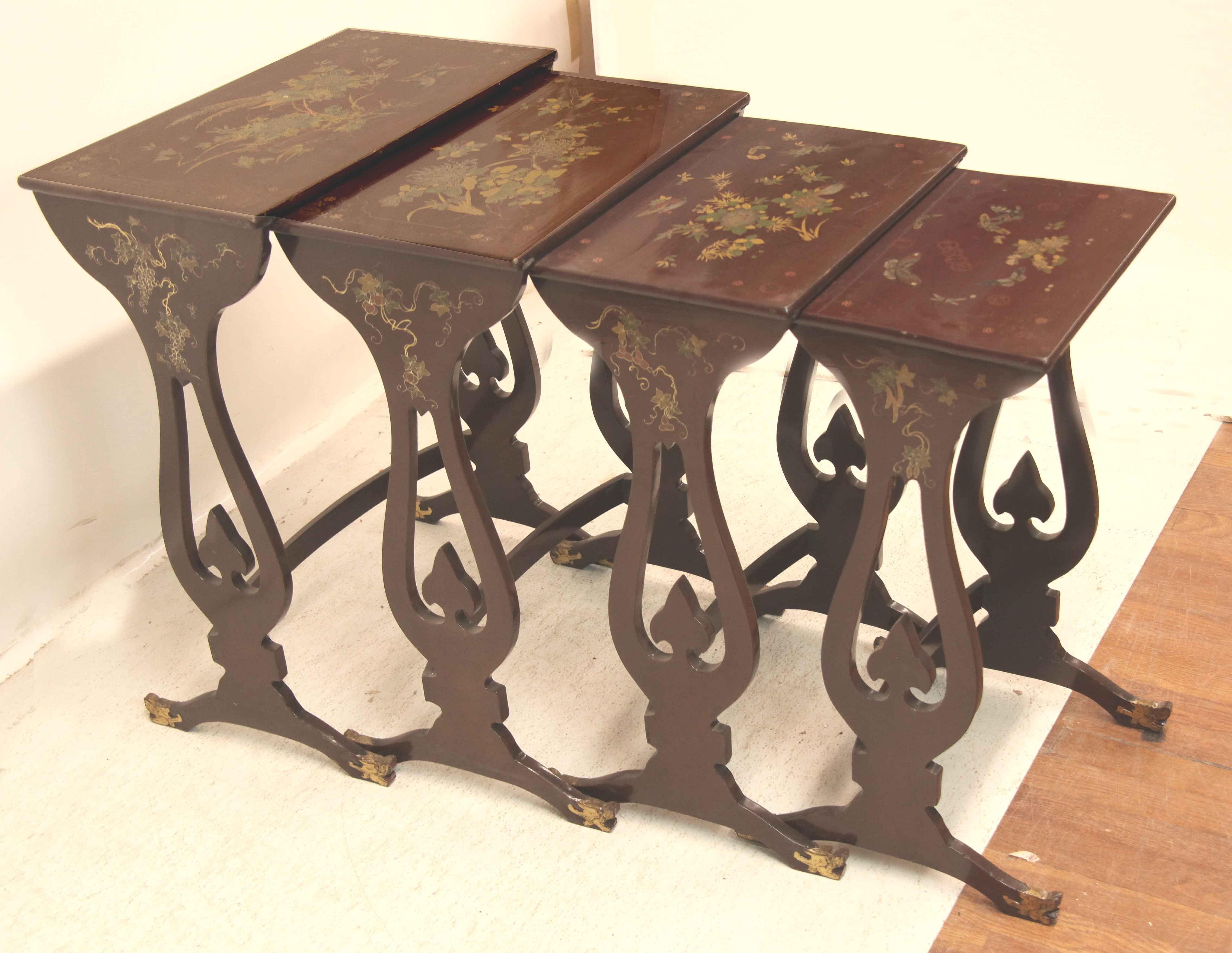 Nest of four lacquer tables, each top with a different scene but similar features- birds, flowers, foliage, butterflies and dragonflies.  The sides have an open design and terminate with a dragon's head.  