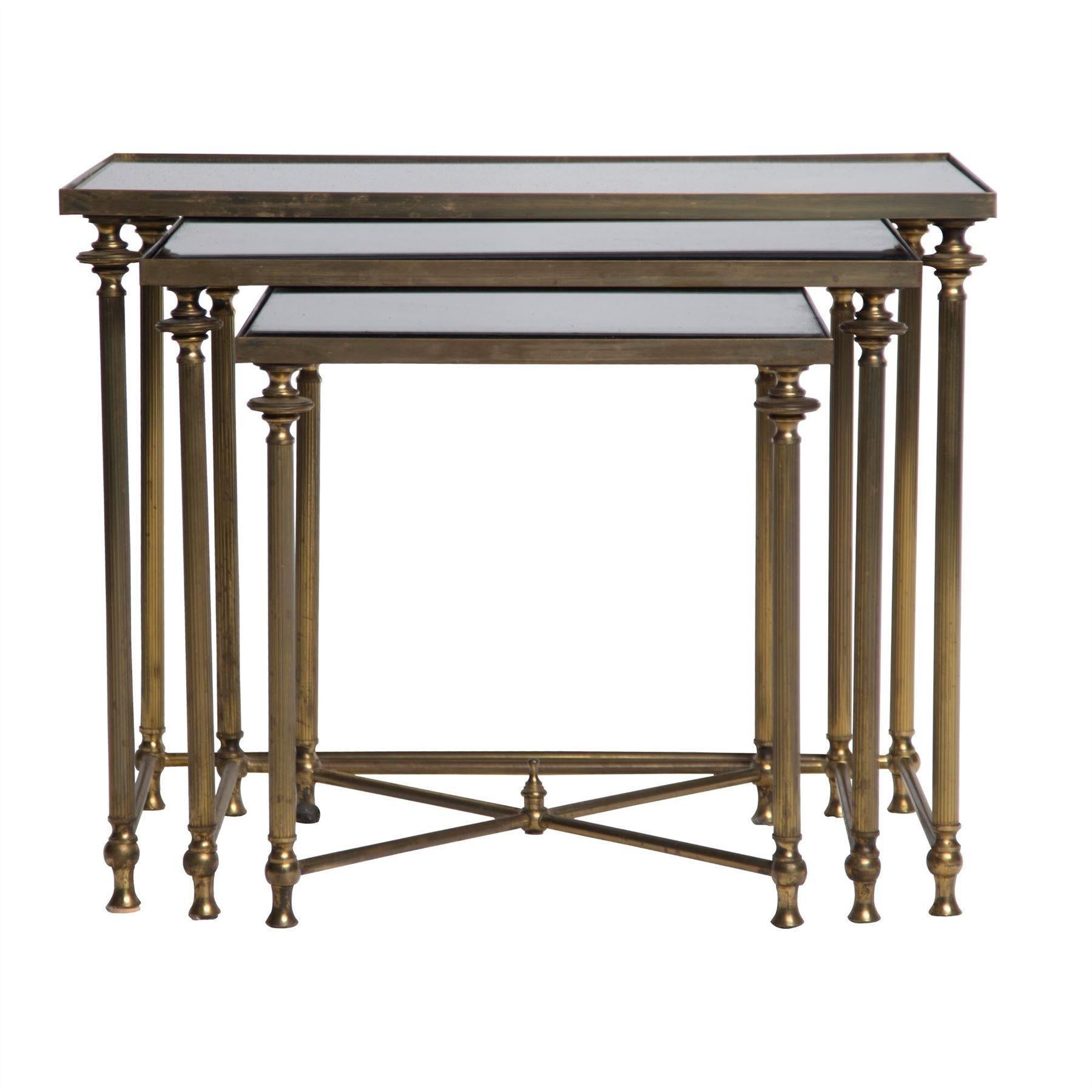 A French mid-20th century nest of brass and mirror tables, circa 1970s.