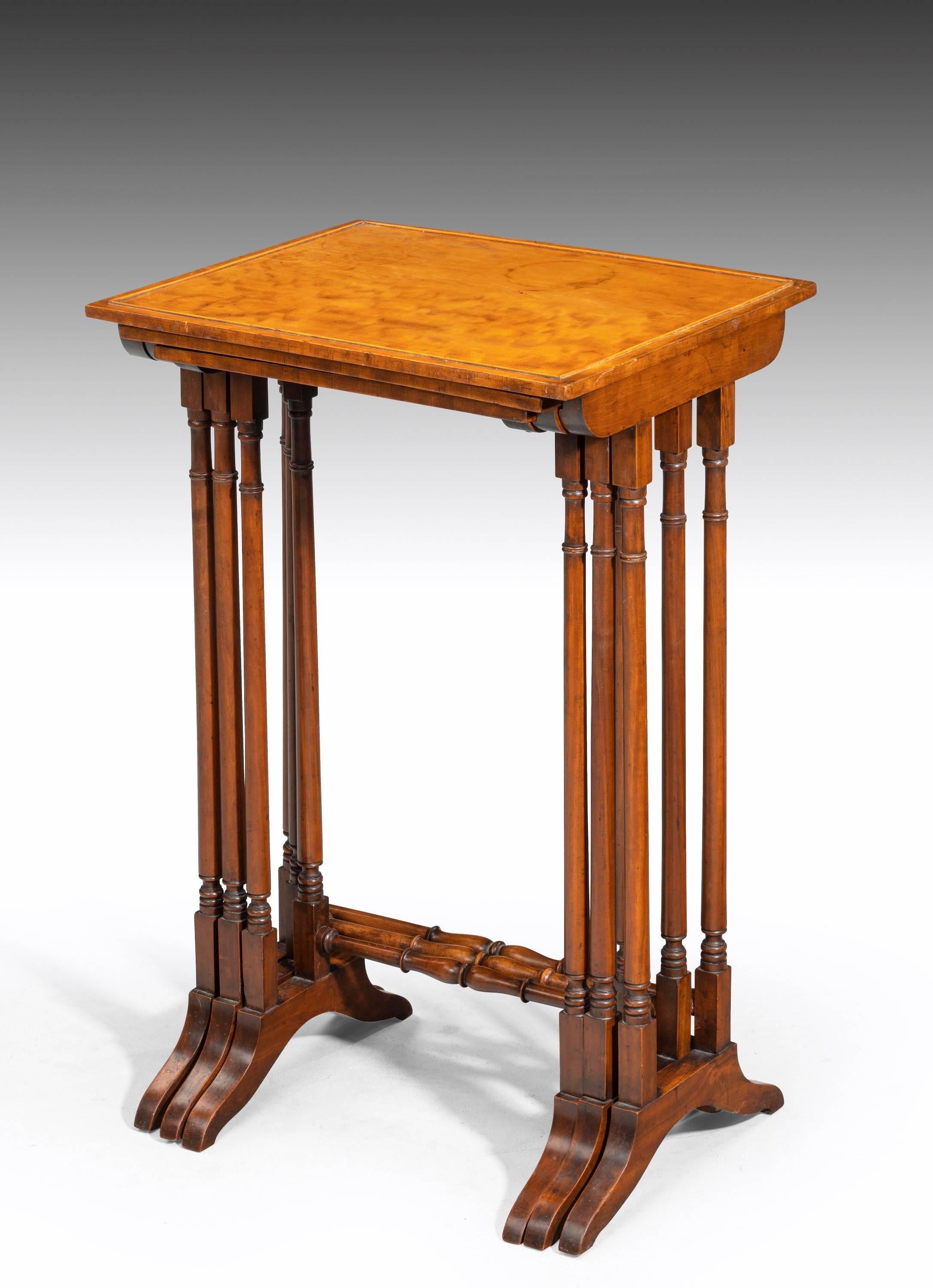 An attractive set Regency period golden mahogany tables on finely turned supports with shoe feet.