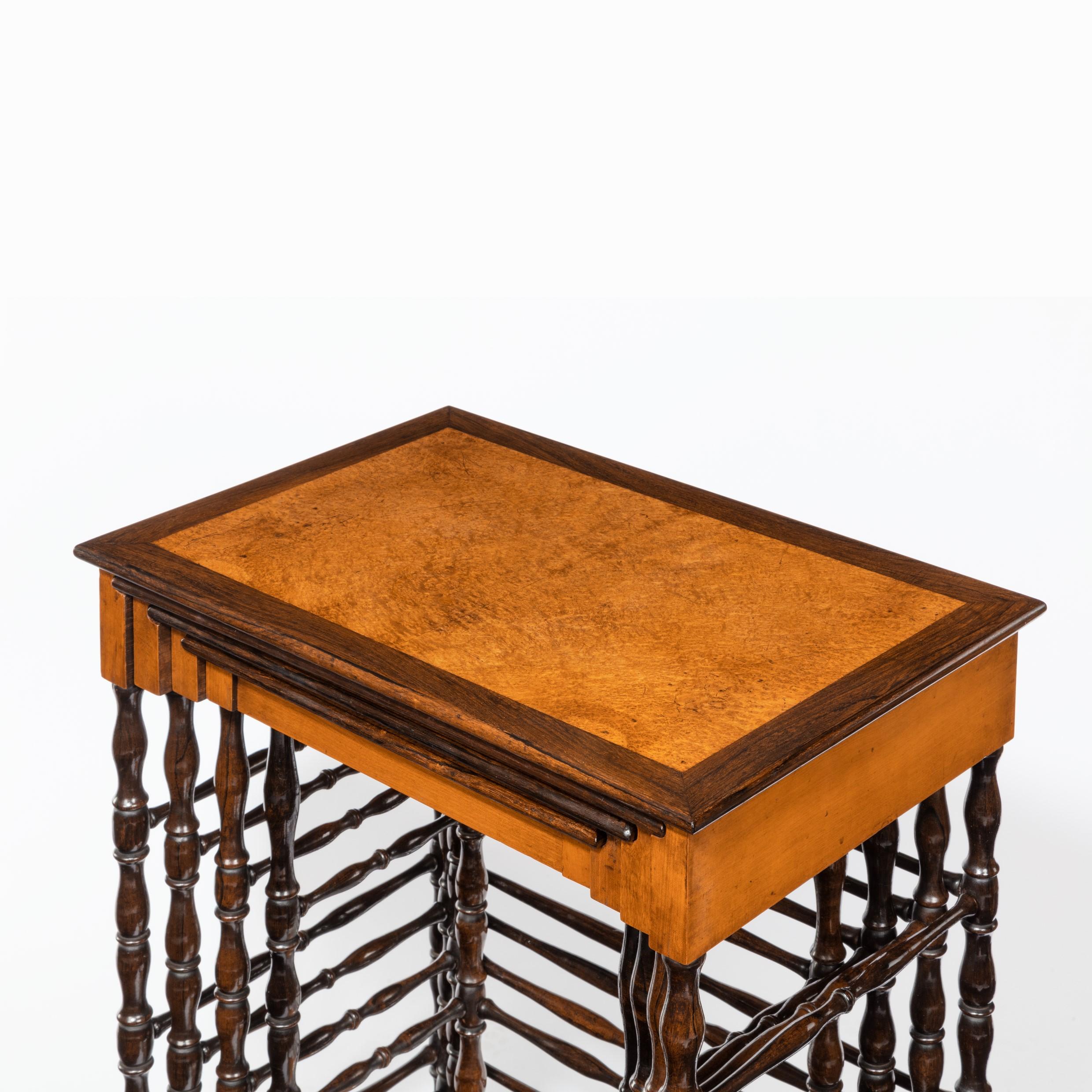 A nest of Regency specimen wood tables by Gillows of Lancaster, each with a rectangular top and rosewood edge, the largest decorated with an amboyna field within rosewood banding, the second rosewood within amboyna, the third bird’s eye maple within