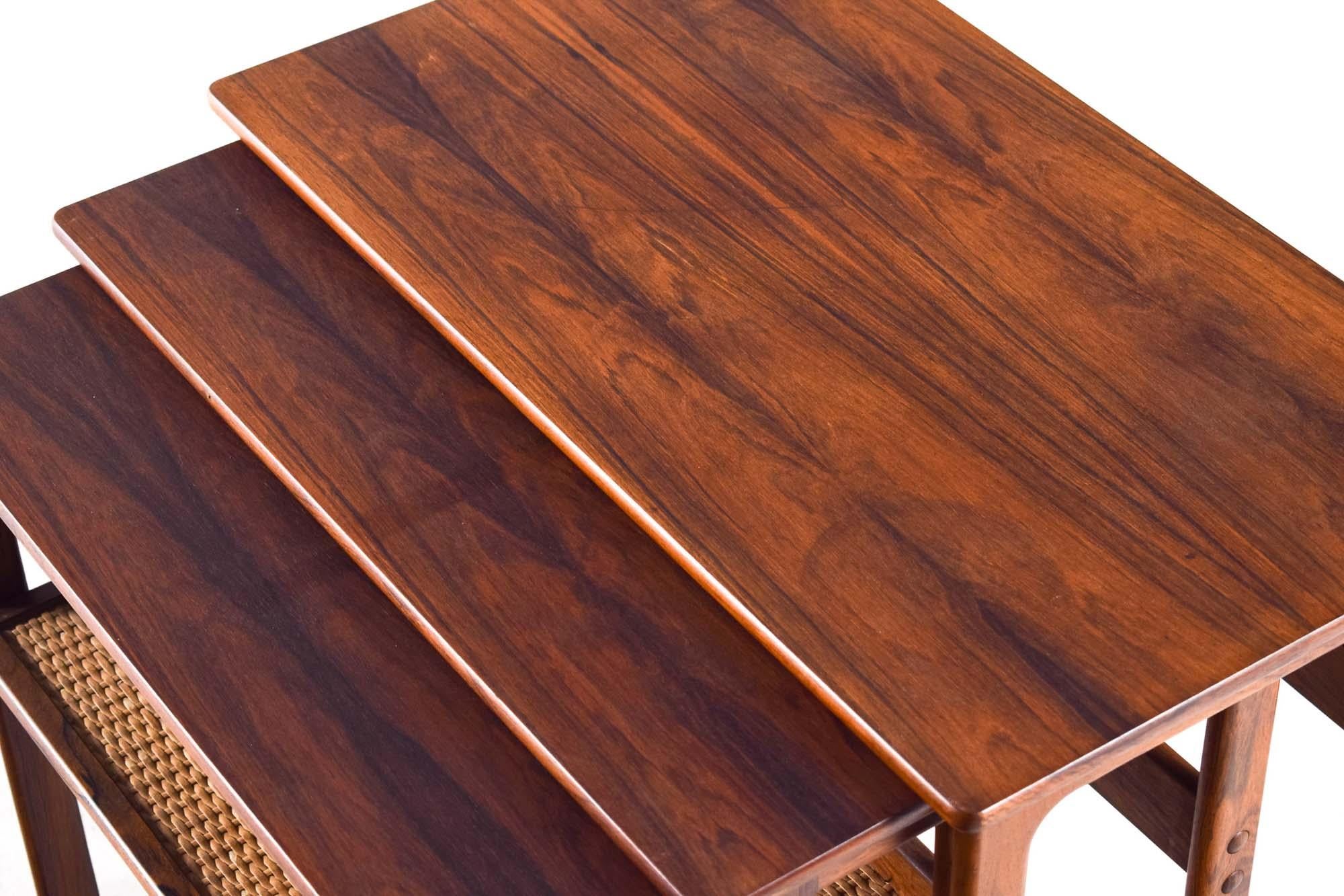 Rare set of three rosewood nesting tables by Danish designers Johannes Andersen & Illum Wikkelsø and produced by CFC Silkeborg. The quality is amazing, these have a gorgeous and very practical design. The rosewood has a lovely colour and wonderful