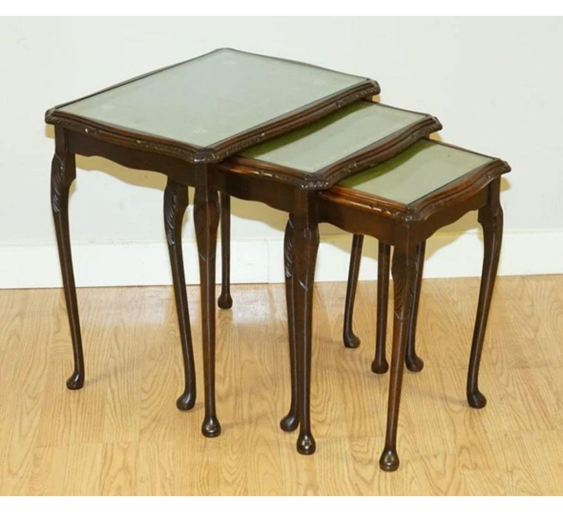 We are delighted to offer for sale this outstanding vintage nest of tables with a green leather top.

All three tables include a glass top for protection from any hot drinks or spills. We have lightly restored this by hand cleaning it, wax and