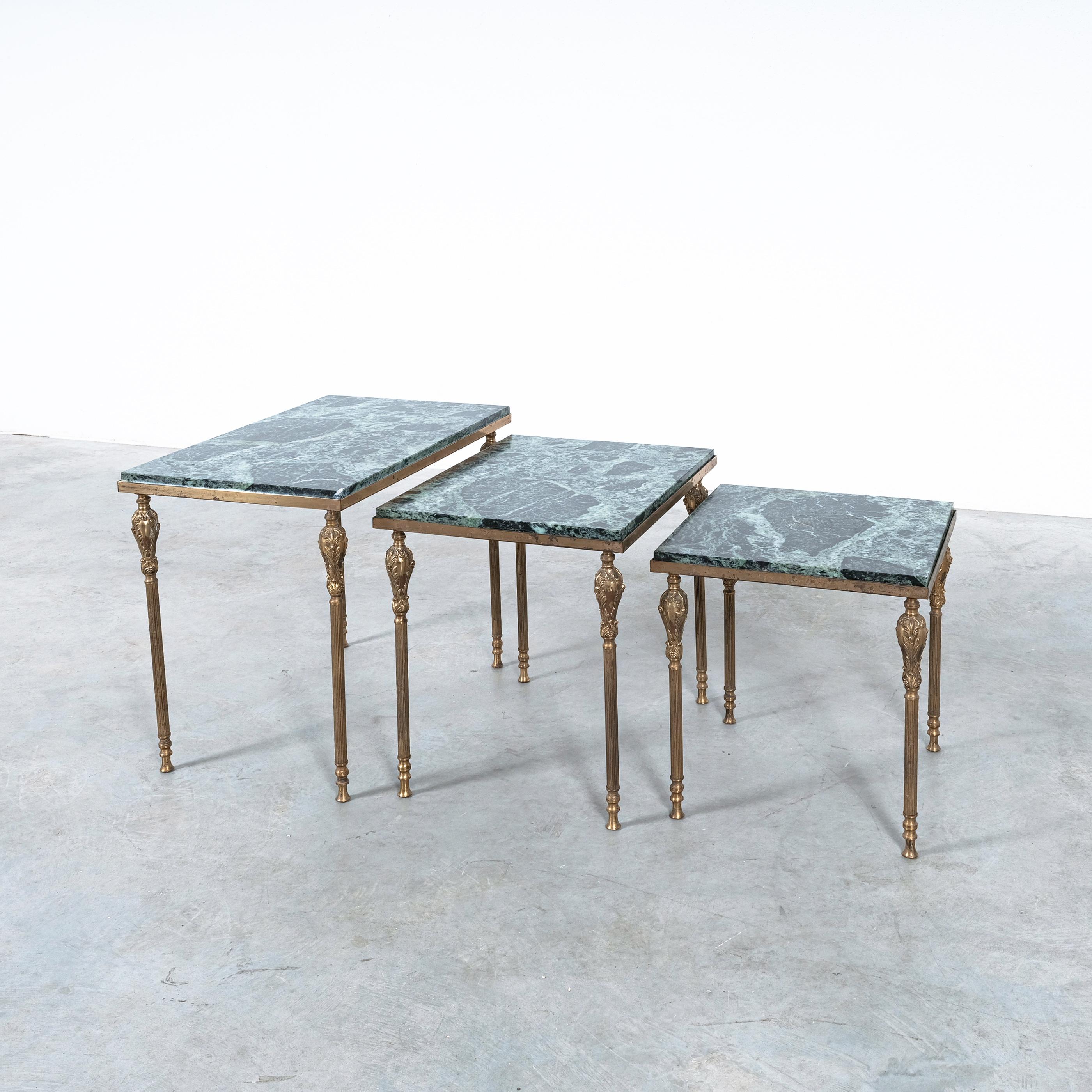 Nest of tables with green marble tops, France circa 1940

Set of three side tables in original vintage mid century condition. The slender columns are from brass and iron and show some corinthian motives like the acanthus leaf. The metal work shows