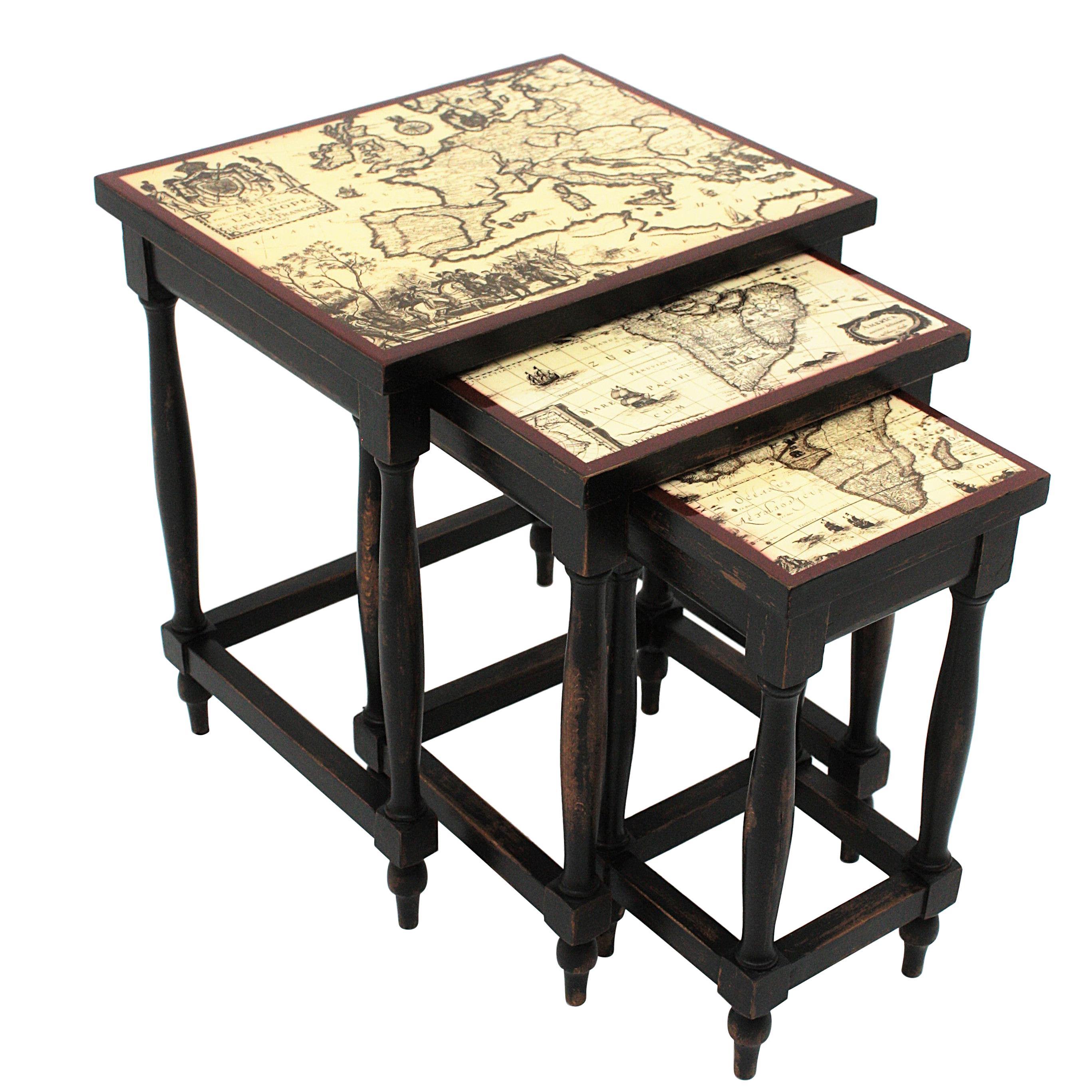 World Maps Themed set of three wooden nesting tables, France, 1940s. 
This set has black patinated turned wood structures with beautiful lacquered maps on the tops. The largest of the three has an Europe Map on the top, the medium sized has an