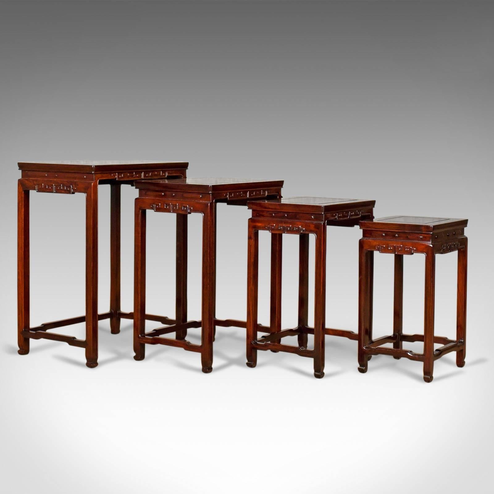 This is a nest of four tables with an Oriental influence, Chinese rosewood side, or occasional, tables from the late 20th century.

Superb craftsmanship and attention to detail
Oriental overtones to styling
Rich, dark tones and good grain