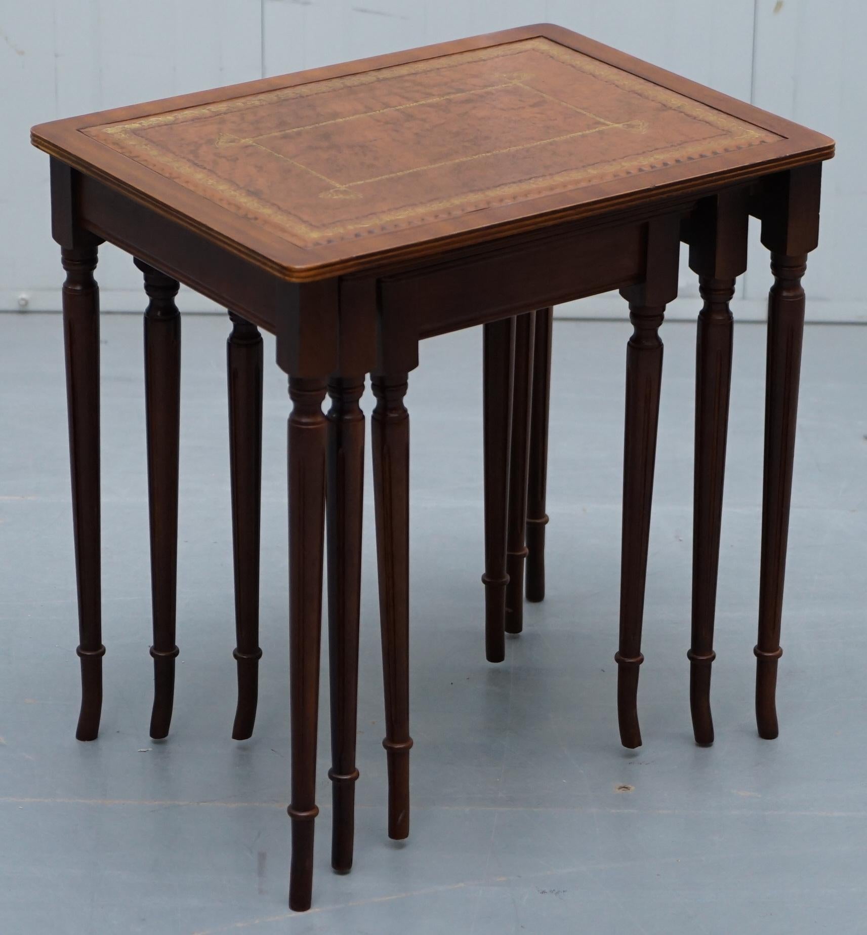 We are delighted to offer for sale this lovely small nest of three Mahogany tables with brown leather gold leaf embossed tops

A very good looking well made suite, most likely retailed through Bevan Funnel or Brights of Nettlebed, they are around