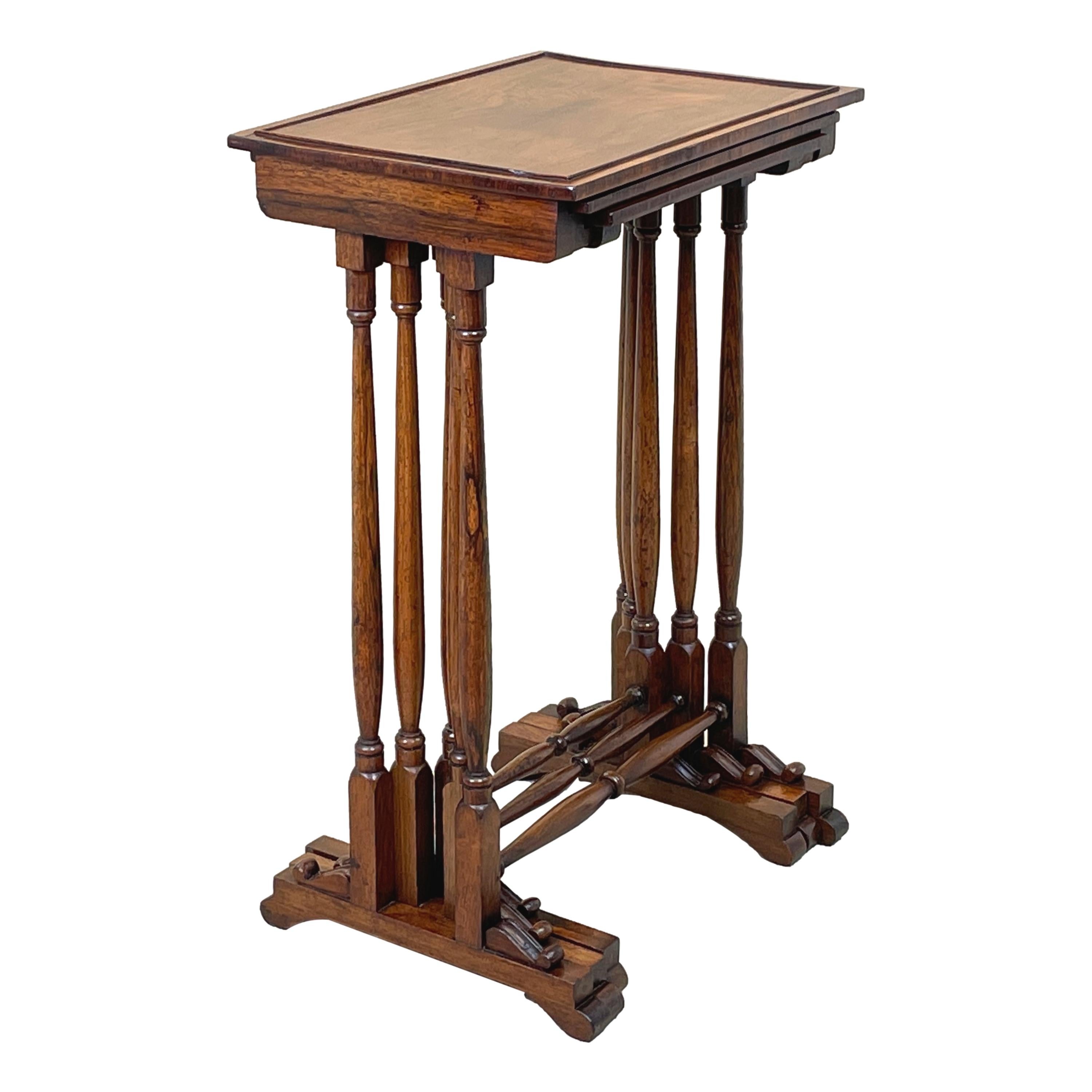 A very good quality Regency nest of three padouk wood coffee tables having extremely well figured cockbeaded tops raised on elegant turned upright supports with attractive scrolling feet

Dating to the late Regency period this nest of three coffee