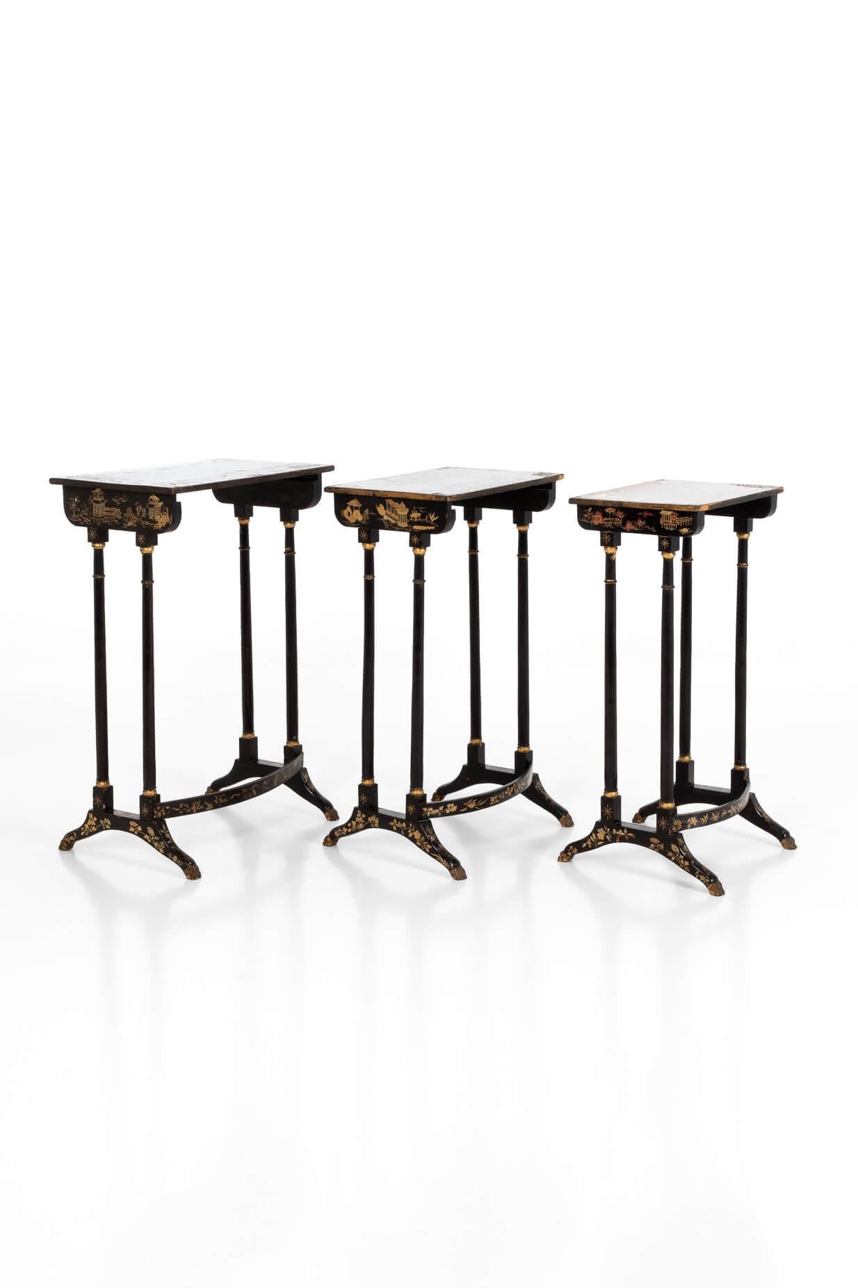 A nest of three wonderful Regency chinoiserie gilt and black lacquer tables. Below the Jappaned surfaces, the table tops are intricately decorated with exquisite scenes from the Far East, with three different scenes depicted on each table. Raised on