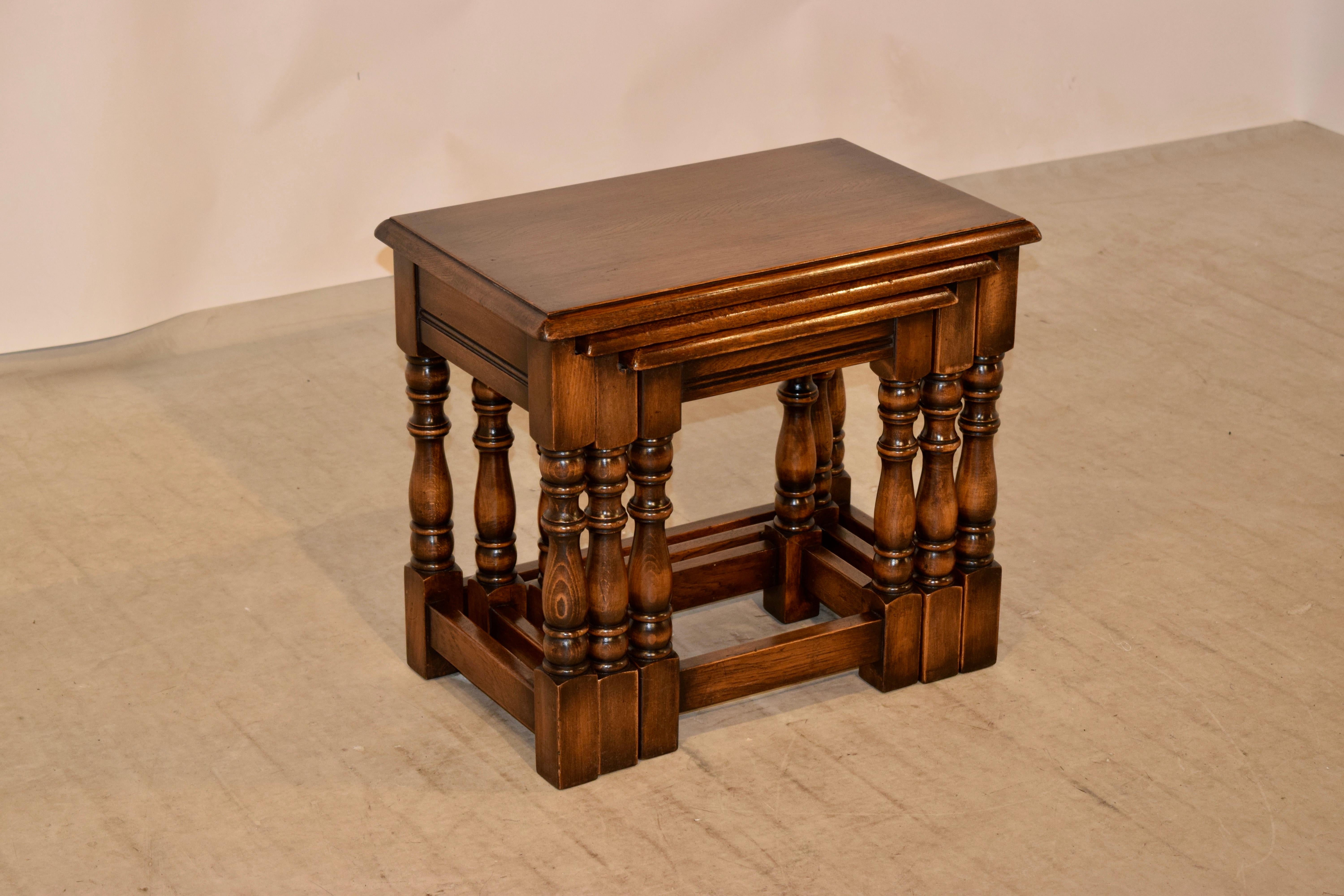 Set of three English oak nested tables with bevelled edges around the tops, following down to simple aprons, and supported on nicely hand-turned legs joined by simple stretchers, circa 1900. Small table measures 14.13 x 10.13 x 17, and the medium