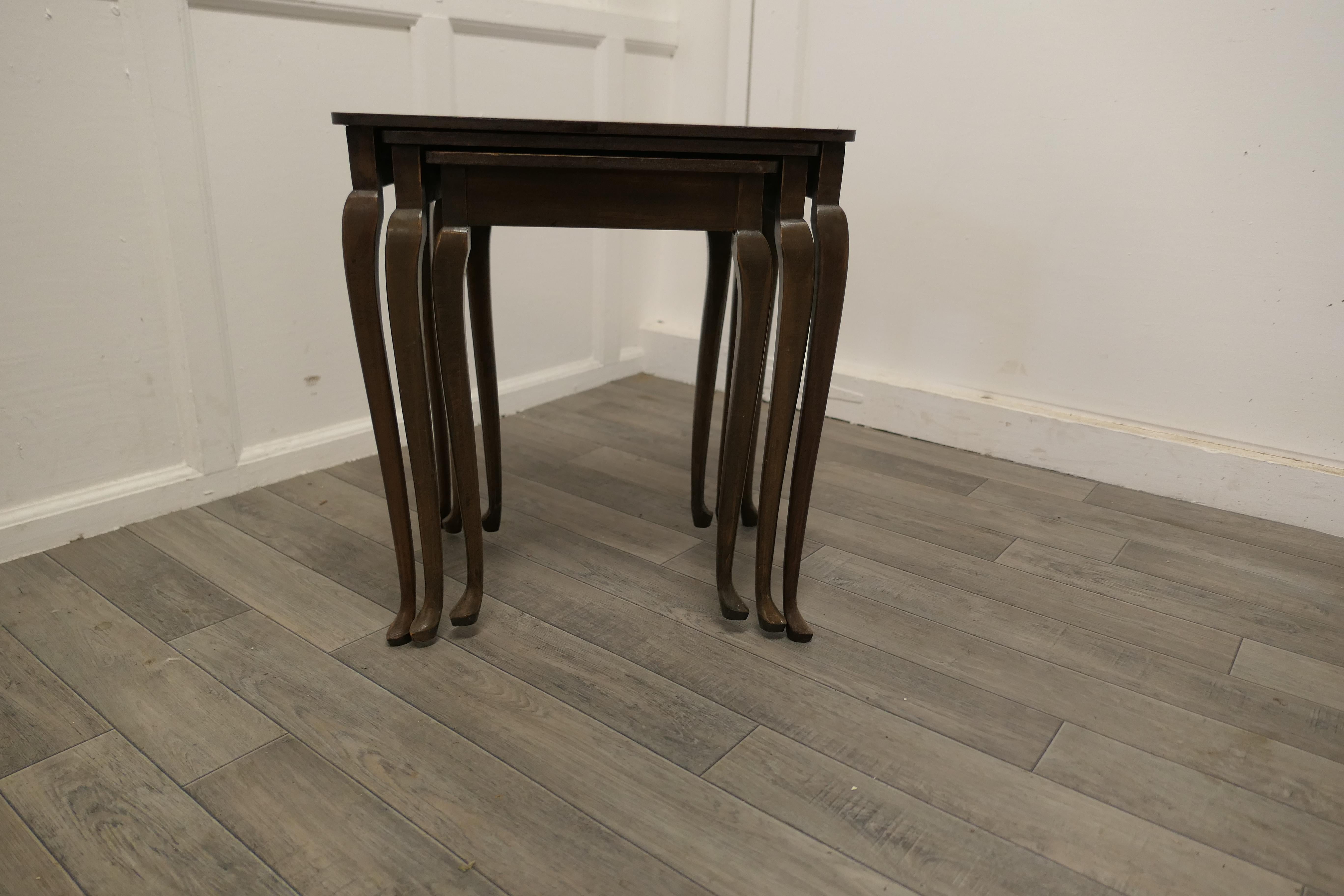 Nest of Three Walnut Art Deco Tables

This is an attractive set of tables, the nest is a set of 3 walnut quarter veneered tables with slender cabriole legs
The tables are sound and in good condition 
As with all Nests of Tables they increase in