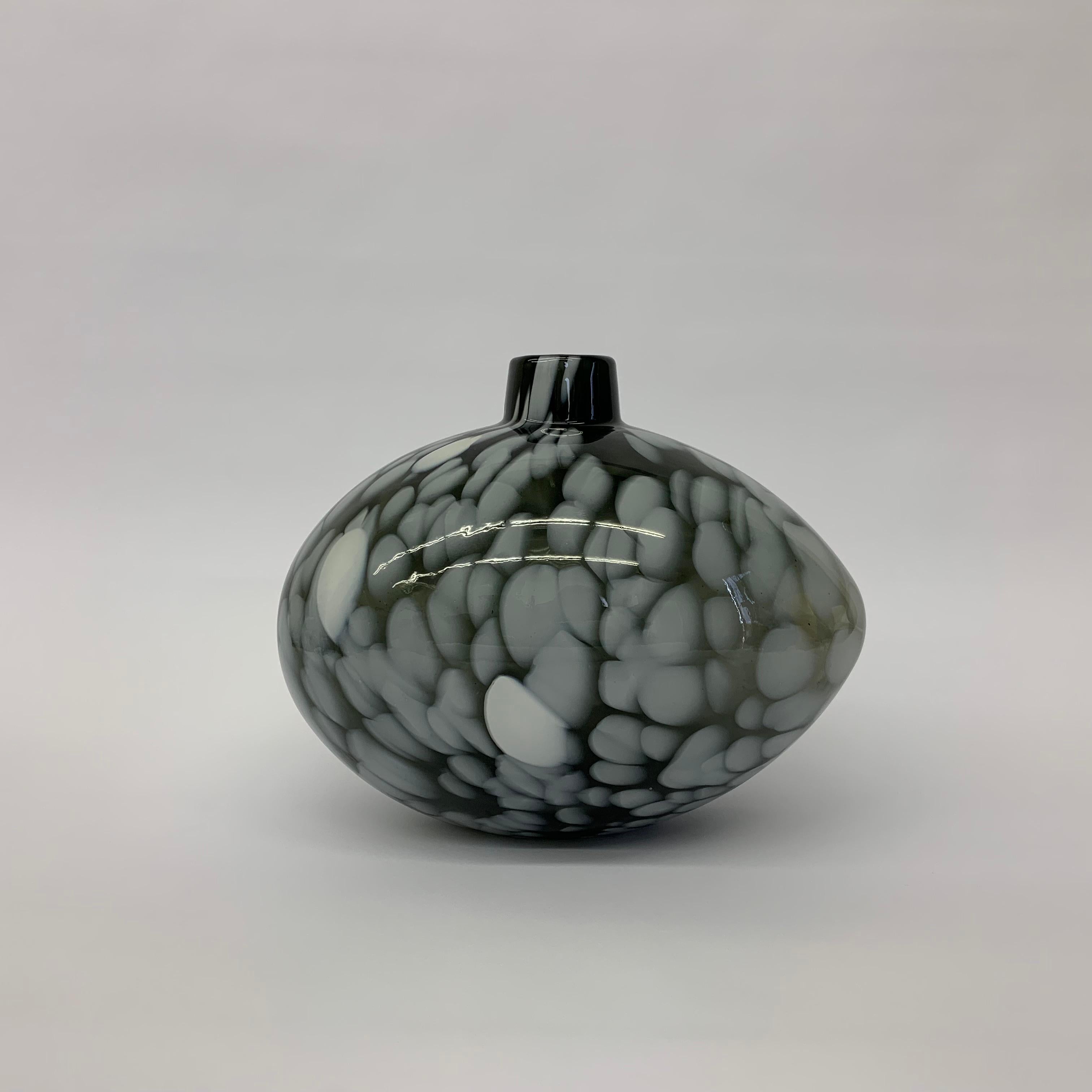 Ann Wahlstrom was retained by Kosta Boda in 1986 and worked out of the Kosta Glassworks. Her designs often reflect a simple fragility in the glass melt combined with the freezing of the introduction of color and design in the hardening process. This