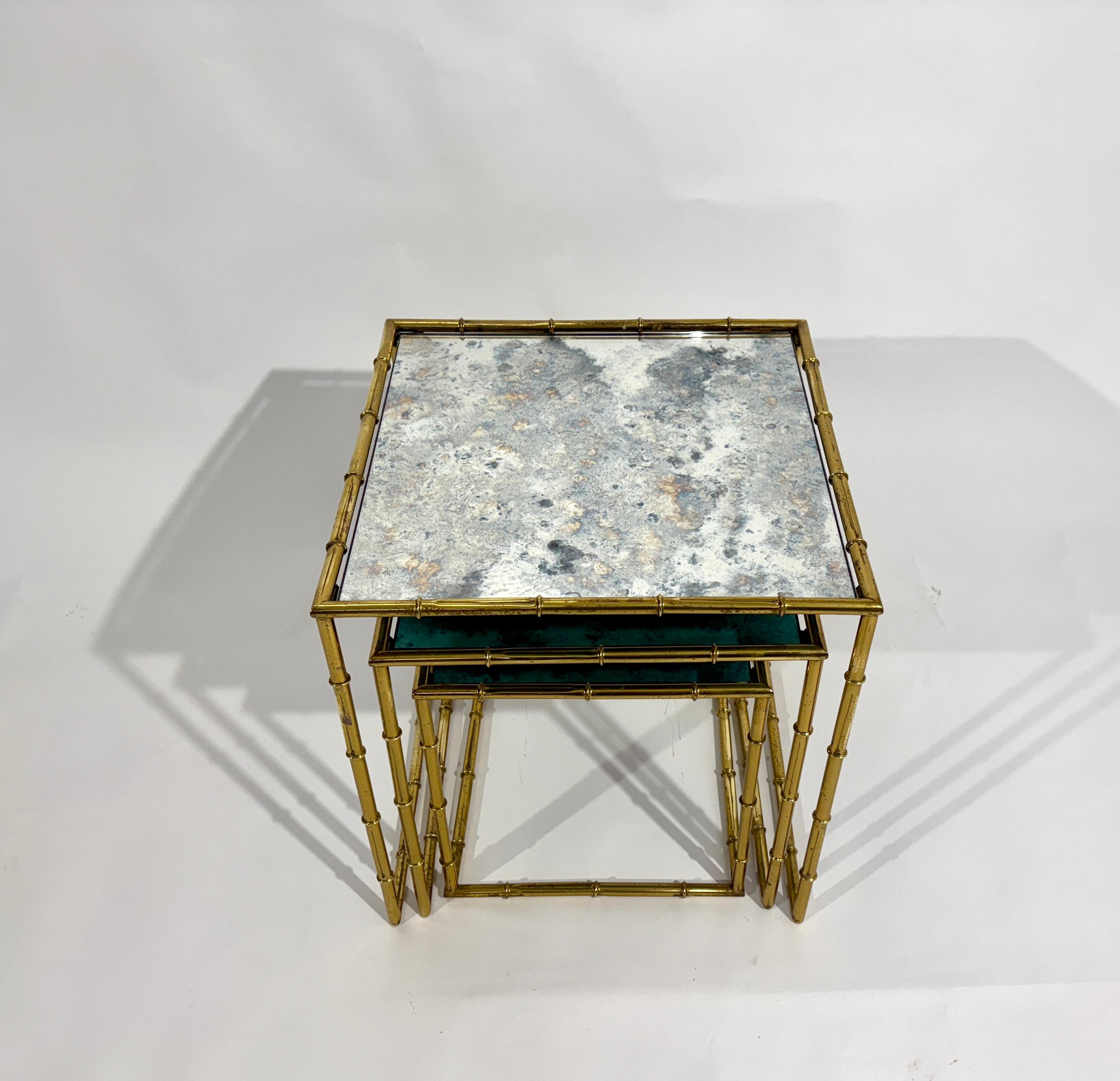 Set of 3 Nesting tables in brass and Mirror glass by Maison Baguès circa's 1950
Dimensions : L : 46X46X48cm, 
                      M : 40x40x41cm.
                      S : 33x33x35cm
Good condition