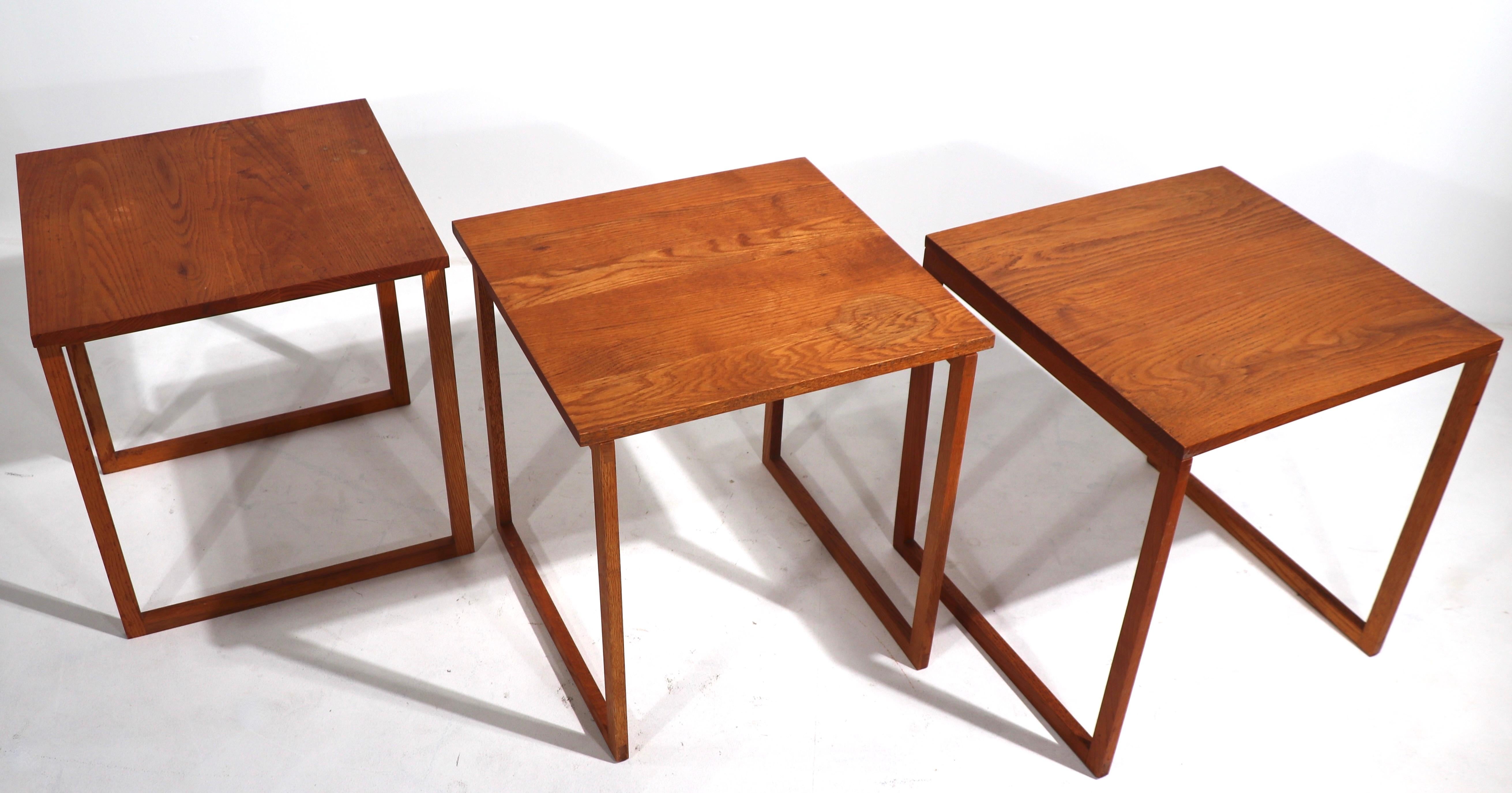 Iconic set of interlocking tables, consisting of 3 tables which when nested form a cube. All three are in very good original condition, the tops show cosmetic wear to the finish, please see images. Classic Danish Modern design, this set exhibits the