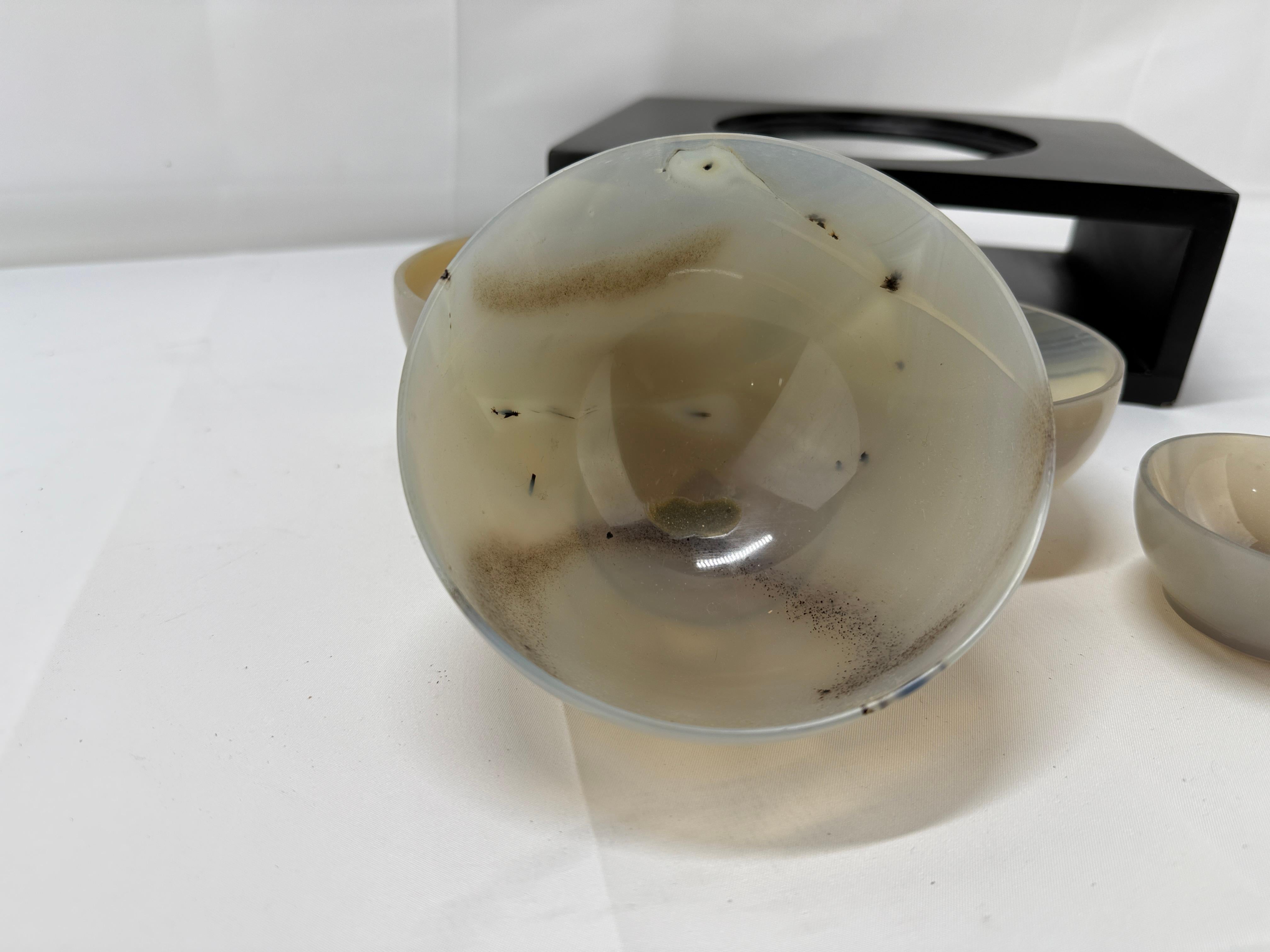 A captivating nesting set of five carved agate bowls, each meticulously crafted from a single piece of natural agate. This set exemplifies the harmonious balance between artistry and nature, showcasing the unique banding and translucency