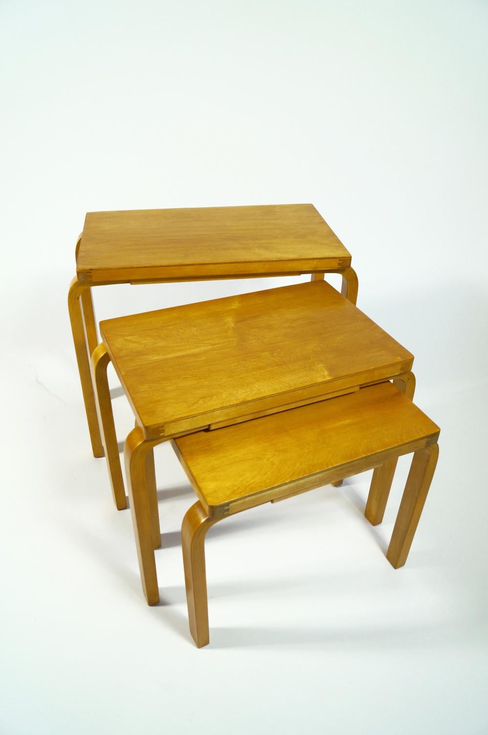 This beautiful and rare trio of nesting tables by Alvar Aalto can serve as side tables, coffee tables, or be used singularly, spread across a room to provide multiple table surfaces. These tables are in original condition and they have gorgeous