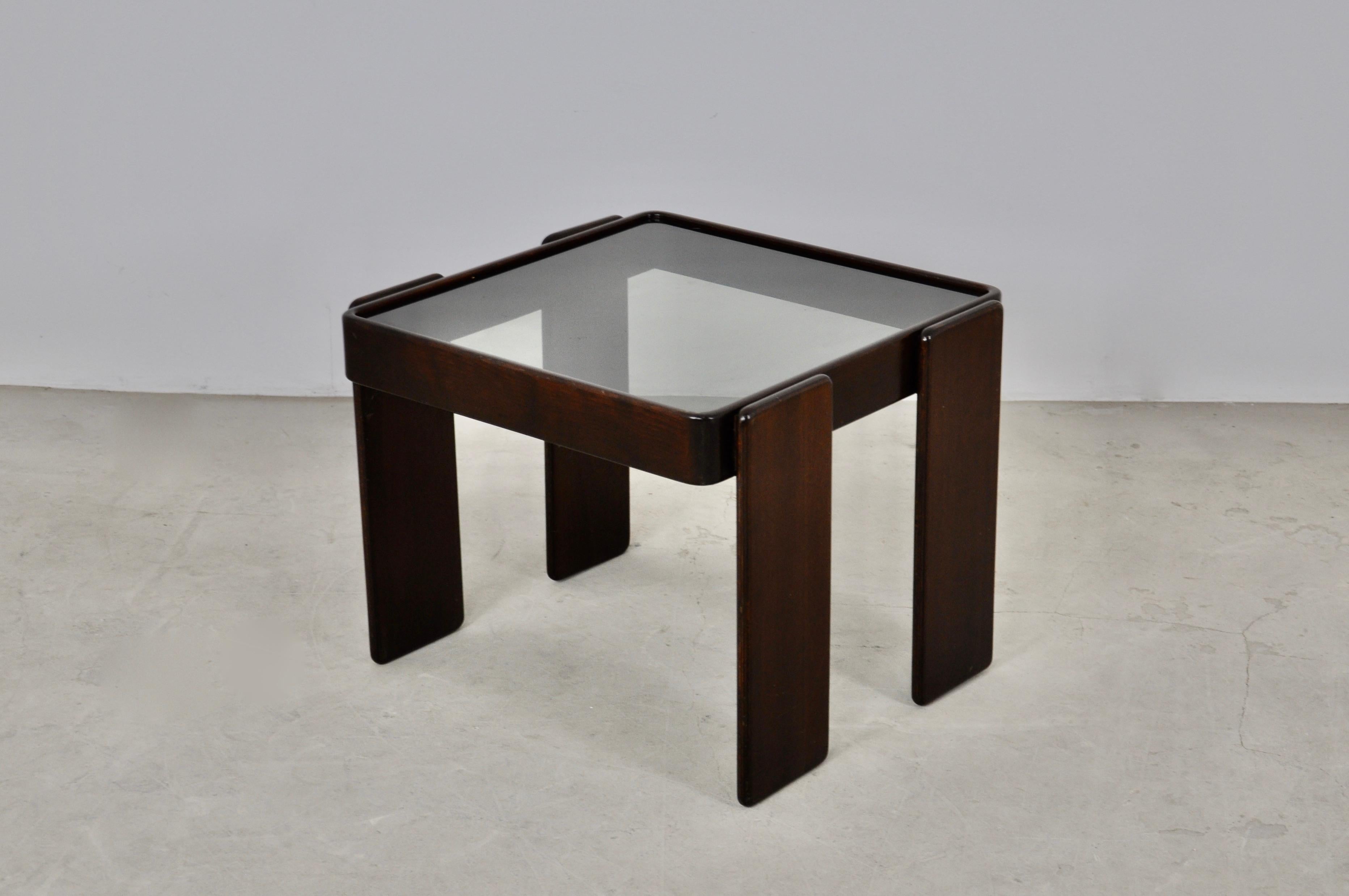 Wooden table and smoked glass top. Wear due to time and age of the table.