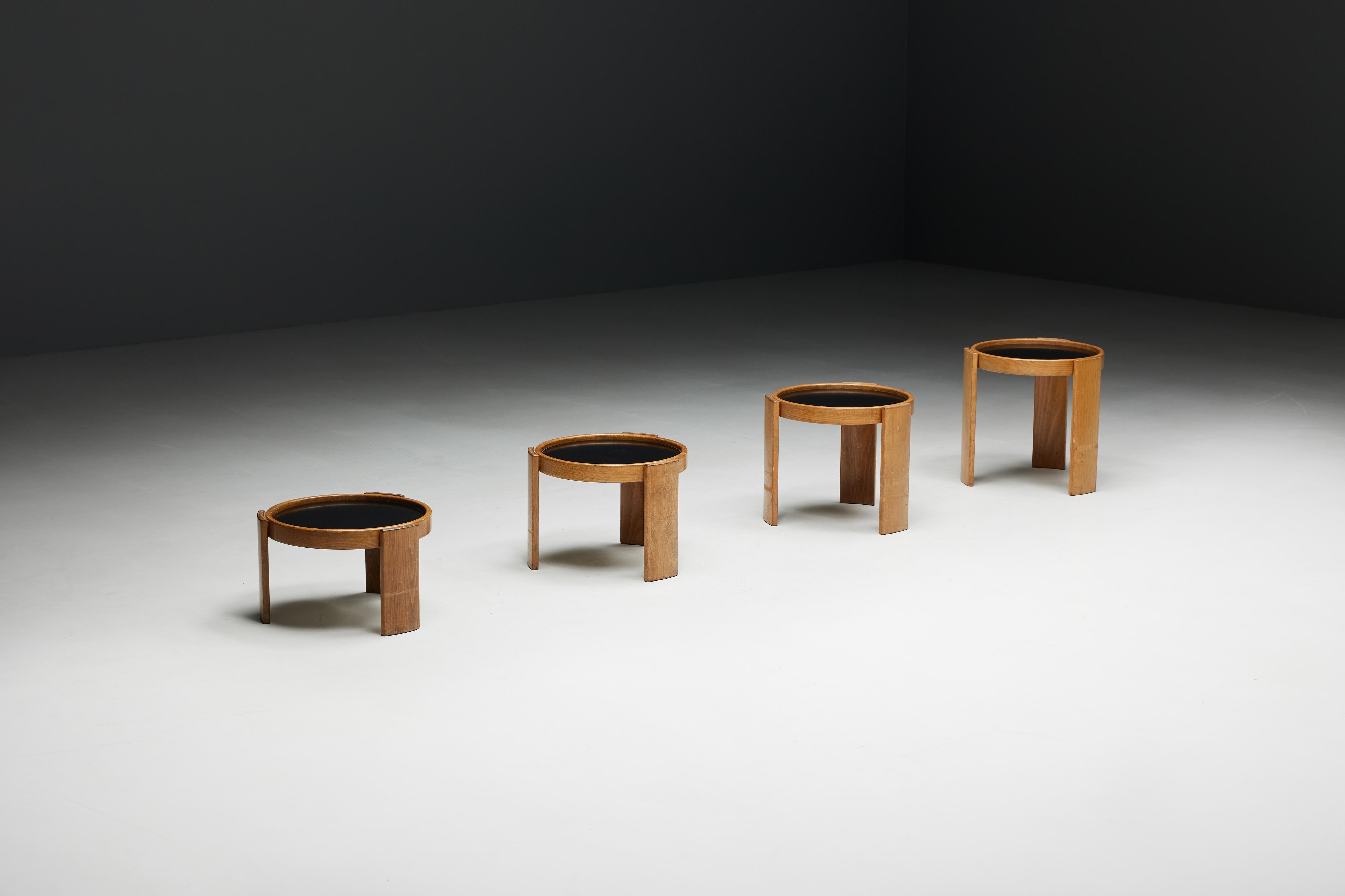 Set of four modular nesting tables by Gianfranco Frattini for Cassina, Model 780. Crafted in 1966 and constructed from original walnut, these side tables feature laminated tops with reversible black or white sides, providing versatility to suit your