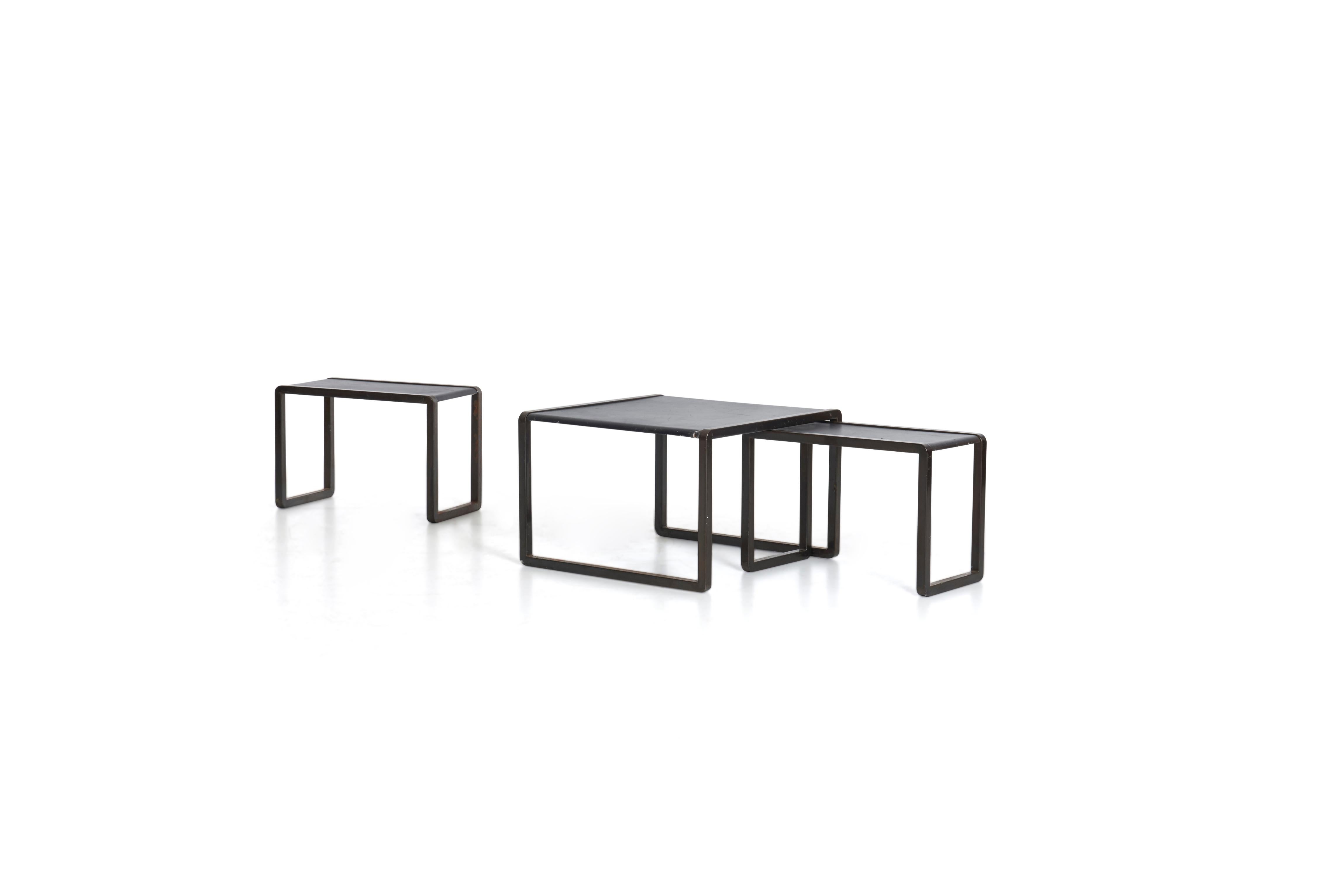 Marco Fantoni for Tecno, these unique nesting tables were designed for Borsani Commission. Bronze painted metal with leather tops.
Measures: Height of largest table 16