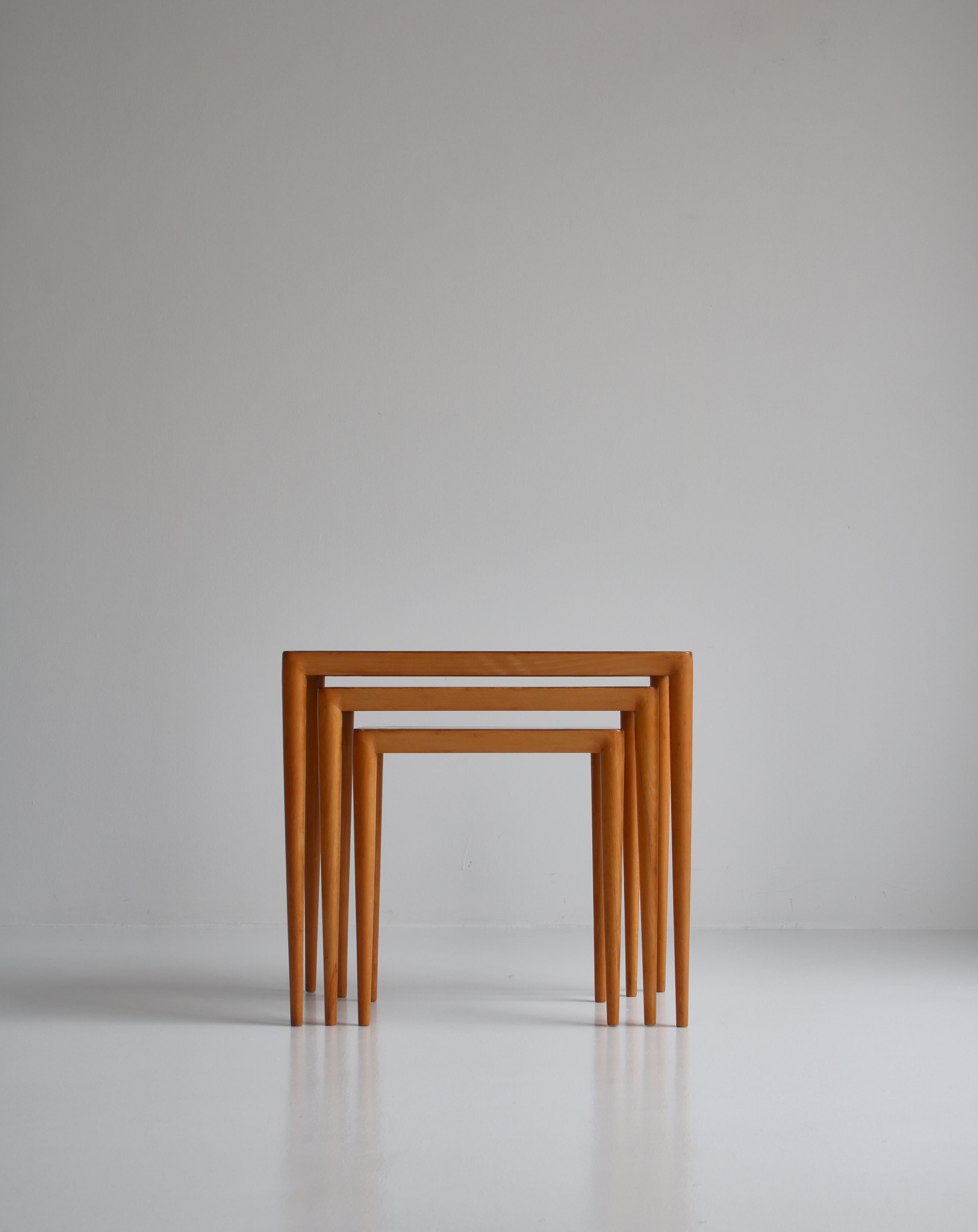 Rare set of vintage Scandinavian Modern nesting tables in birchwood and beech by Erik Severin Risager-Hansen. The skillfully crafted tables features subtle details such as the soft rounded edges and the wonderful warm grain of the birch veneer. The