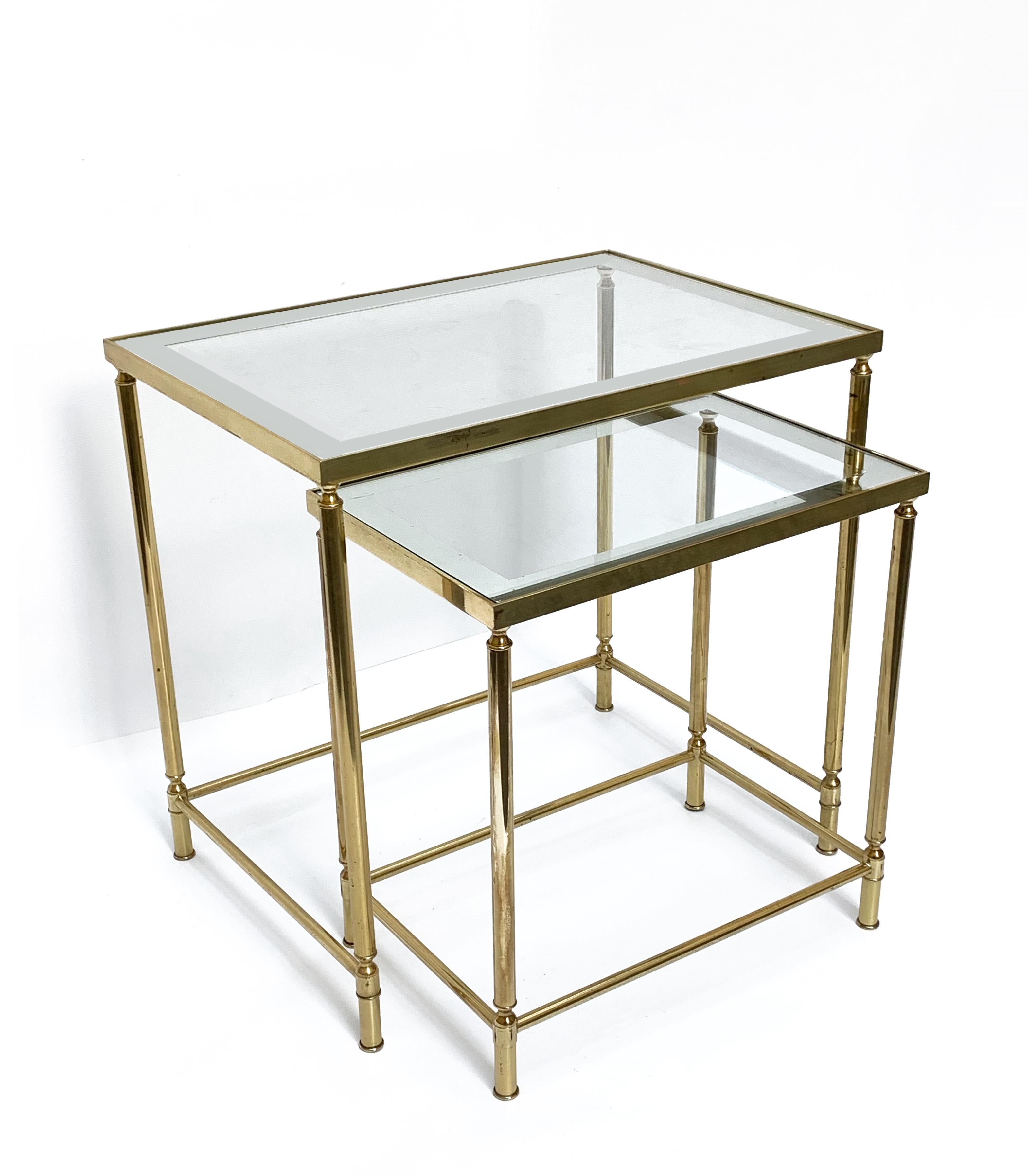 This low set of two nesting tables made in brass and mirrored glass was produced by Maison Jansen.