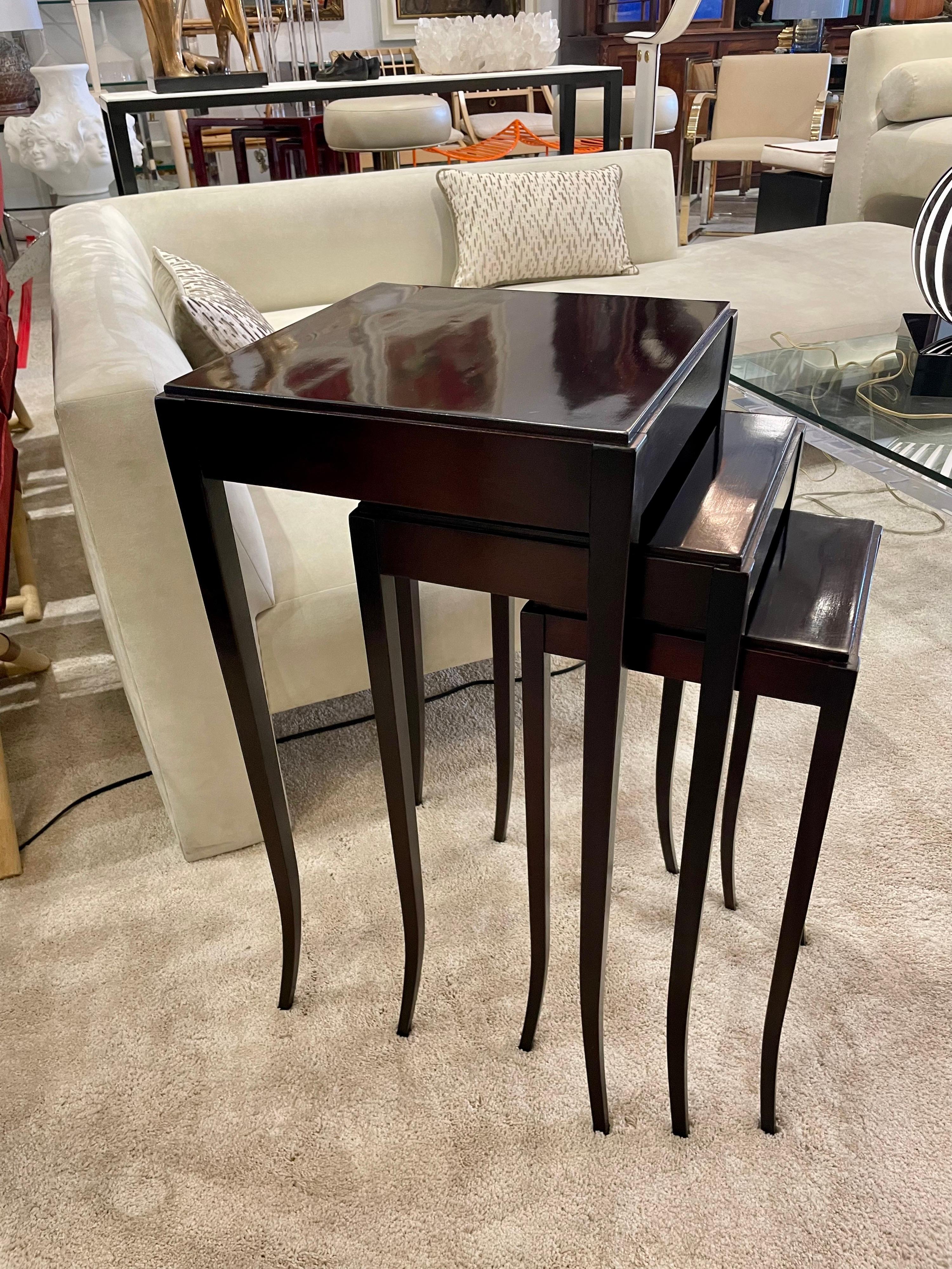A gorgeous Barbara Barry set of nesting tables w/ splayed legs for Baker Furniture. In a rich dark burnt umber mahogany, this set is in great vintage condition (see ALL detail images). Dimensions of all tables: Large 28.75 inches tall, 14.5 x 14.5