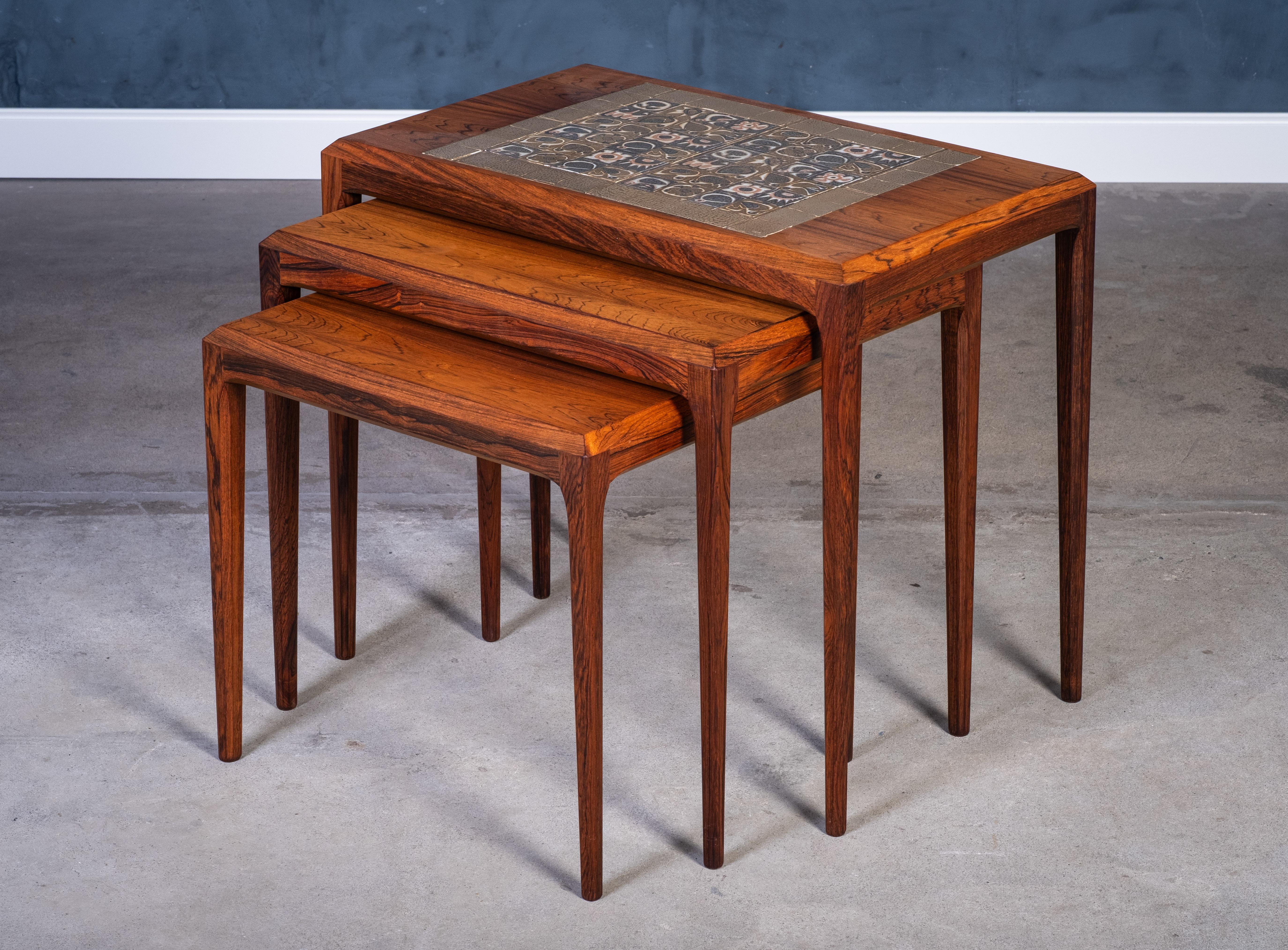 legant and versatile set of nesting tables designed by Johannes Andersen and produced by CFC Silkeborg in the 1960s. Crafted from richly grained rosewood and featuring distinctive ceramic tile inlays, these tables are a fine example of Danish